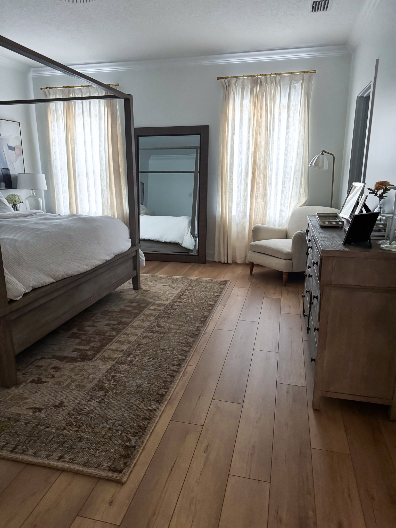 Neutral bedroom. Pottery Barn canopy bed. Amazon curtains in ‘ivory white’, 52”x96” and look so expensive! Pottery Barn light. Pottery barn rug. Target neutral accent chair. Target floor lamp. Target lamps. Bedroom decor. White bedding. 

*Floors are Calypso Oak by Coretec and paint is Extra White by Sherwin Williams

#LTKFamily #LTKHome #LTKFindsUnder100