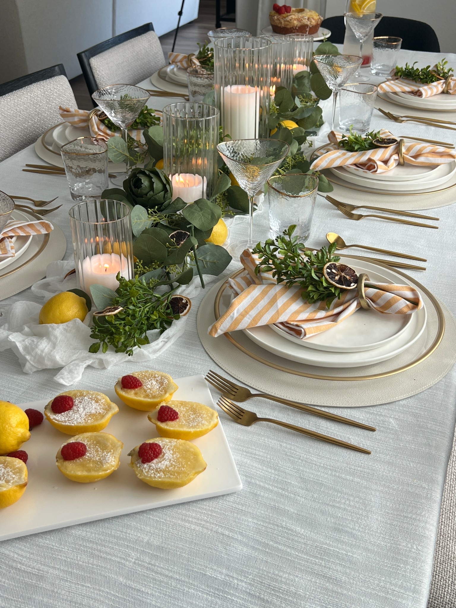 Fresh lemons carried through every detail—from place cards to napkin styling, dessert, and infused water—create a simple, cohesive table that feels elevated and intentional; lemon place cards, vellum name tags, gold pins, dried lemon slices, linen napkins, white plates, layered place settings, citrus centerpiece, fresh lemons, glass pitcher, infused water, coupe glasses, dessert plates, lemon cake, lemon posset, neutral table decor, spring table, hosting essentials, entertaining at home

#LTKSeasonal #LTKHome #LTKfoodie