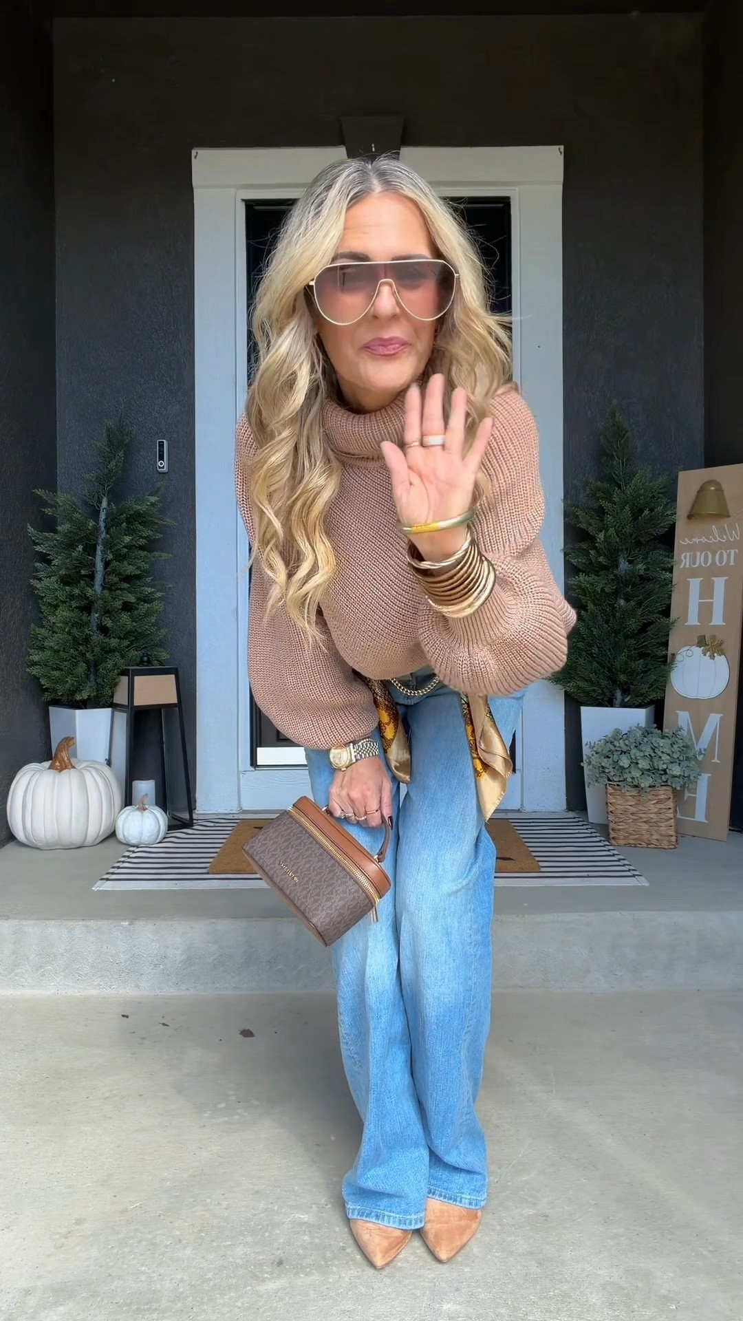 Fall going-out outfit with blue jeans, a beige asymmetrical turtleneck sweater, and pointed-toe kitten heel boots. A gold chain belt, scarf, statement jewelry, sunglasses, and a small crossbody bag take a simple jeans-and-sweater outfit from casual to dinner-and-drinks ready without feeling overdressed. 

 #LTKootd #LTKSeasonal #LTKOver40