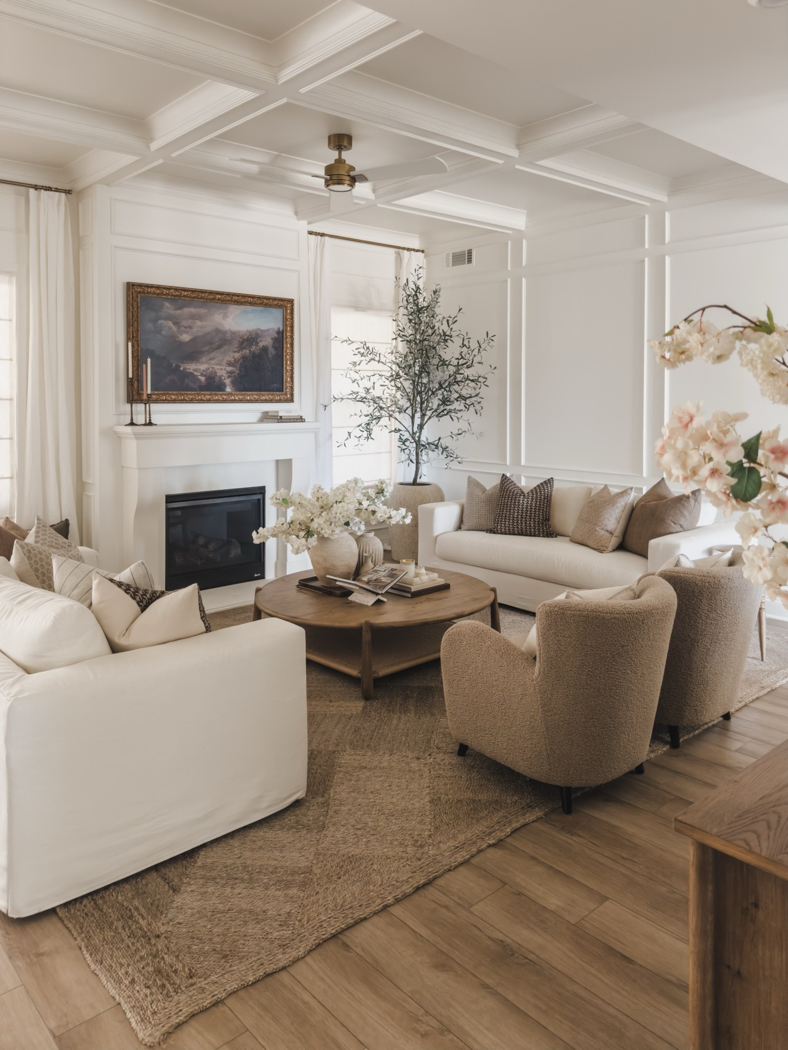 Timeless neutral spring living room with pops of seasonal florals, cozy throw pillows, and creamy linen detail.

Home finds, living room refresh, spring refresh, open concept living room, neutral area rug, Pottery Barn style, aesthetic home, Pottery Barn style, neutral accent chair, spring florals, slipcover sofa, frame tv, faux olive tree, coffee table details, gold detail, ceiling fan, creamy linen, timeless neutrals, Wayfair, shop the look!

#LTKHome #LTKSeasonal #LTKStyleTip