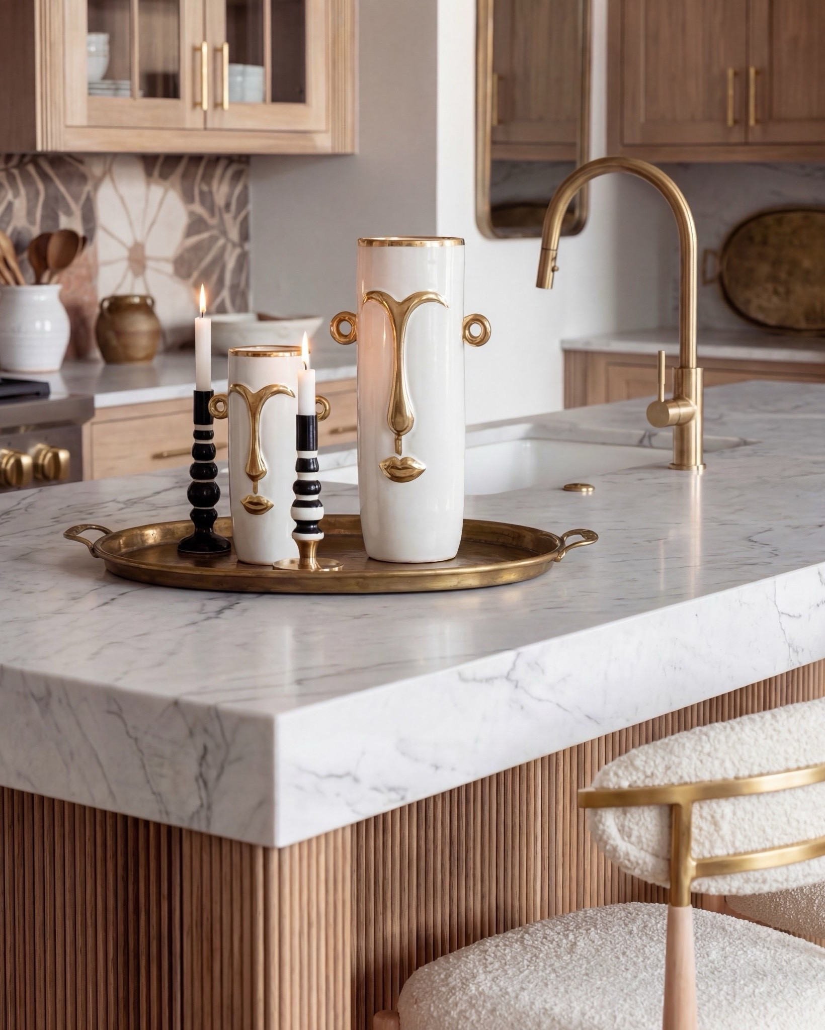 This kitchen is the definition of warm luxury done right. The natural oak cabinets, fluted island detailing, and marble counters create that soft, elevated palette everyone’s obsessed with right now. And can we talk about the pendants? Those sculptural white + brass beauties pull the whole space together.

The mixed-tone floral backsplash adds the perfect touch of personality without overwhelming the room, and the white range with brass hardware… she’s the star. Layered marble, muted runner, boucle bar stools, and gold accents make everything feel curated but still livable.

Shop the Look:
• Natural oak cabinetry (with fluted island detail)
• White + brass sculptural pendant lights
• White gas range with brass trim
• Warm floral tile backsplash
• Boucle + brass bar stools
• Marble countertops (soft veining)
• Brass kitchen hardware
• Ceramic vases + stone serveware
• Neutral vintage runner
• Gold tray + candle holders
• Oak beams (warm rustic contrast)

#LTKSaleAlert #LTKSpringSale

#LTKsale #LTKhome