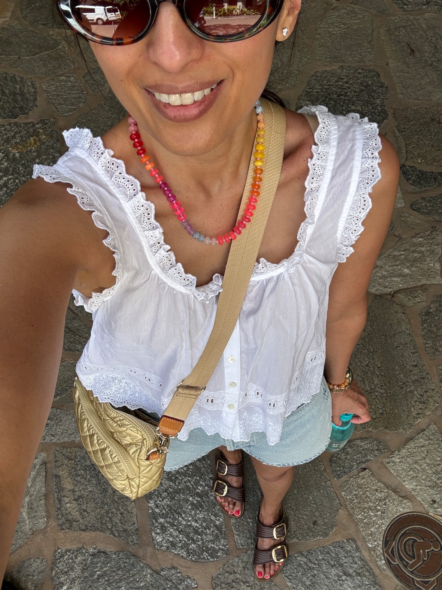 Vacation outfit. Spring break. 
White tank top
Denim shorts 
Beaded stone necklace 
Sunglasses 
Crossbody camera bag
Raffia slide sandals 

