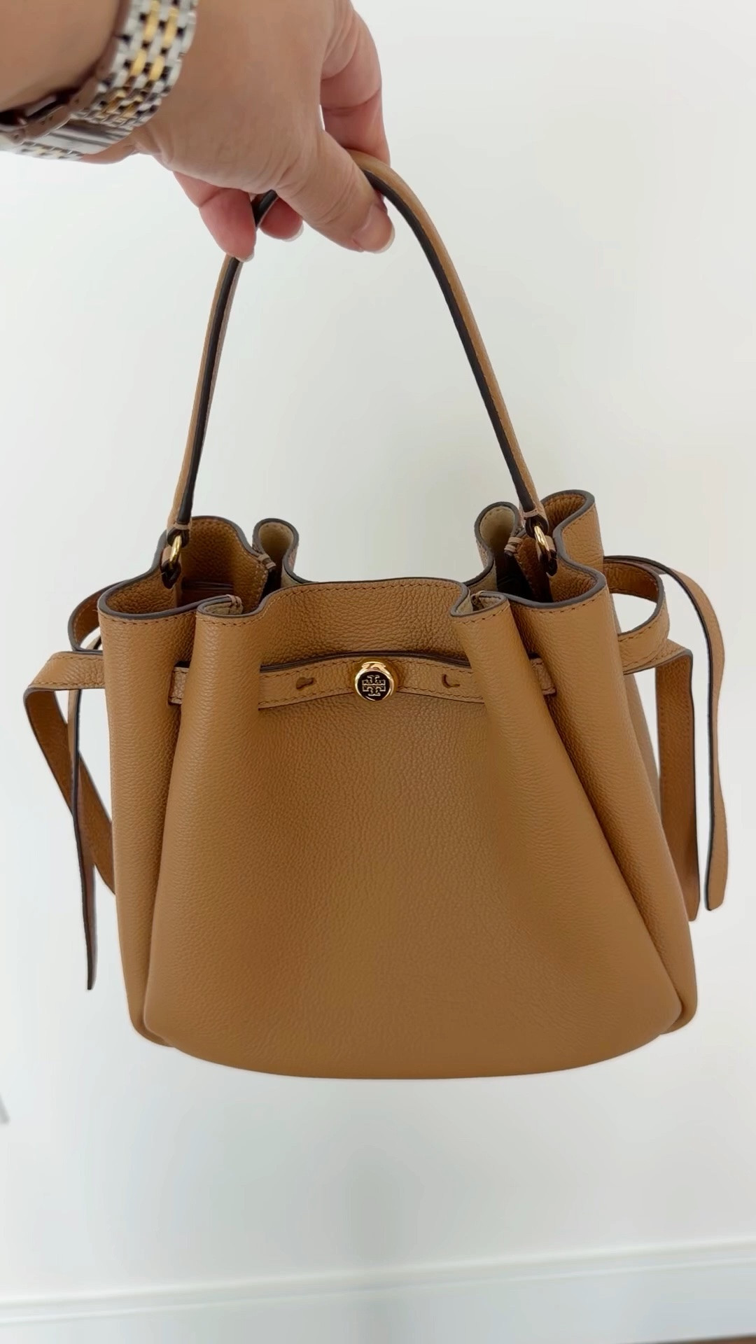 Love this Tory Burch bucket bag style in this gorgeous tan color! The perfect complement to all of your fall outfits! Lots of other new Tory Burch bags available too including raffia, straw, crochet and suede styles as well as a new clear jelly bag style that are perfect for vacation outfits beach and resort wear. Always love the classic pebbled leather colors for everyday wear, workwear and travel outfits. It also comes with a longer crossbody strap so you can wear the bag hands free. A great bag that can be used all year round in every season!

#LTKOver40 #LTKWorkwear #LTKTravel