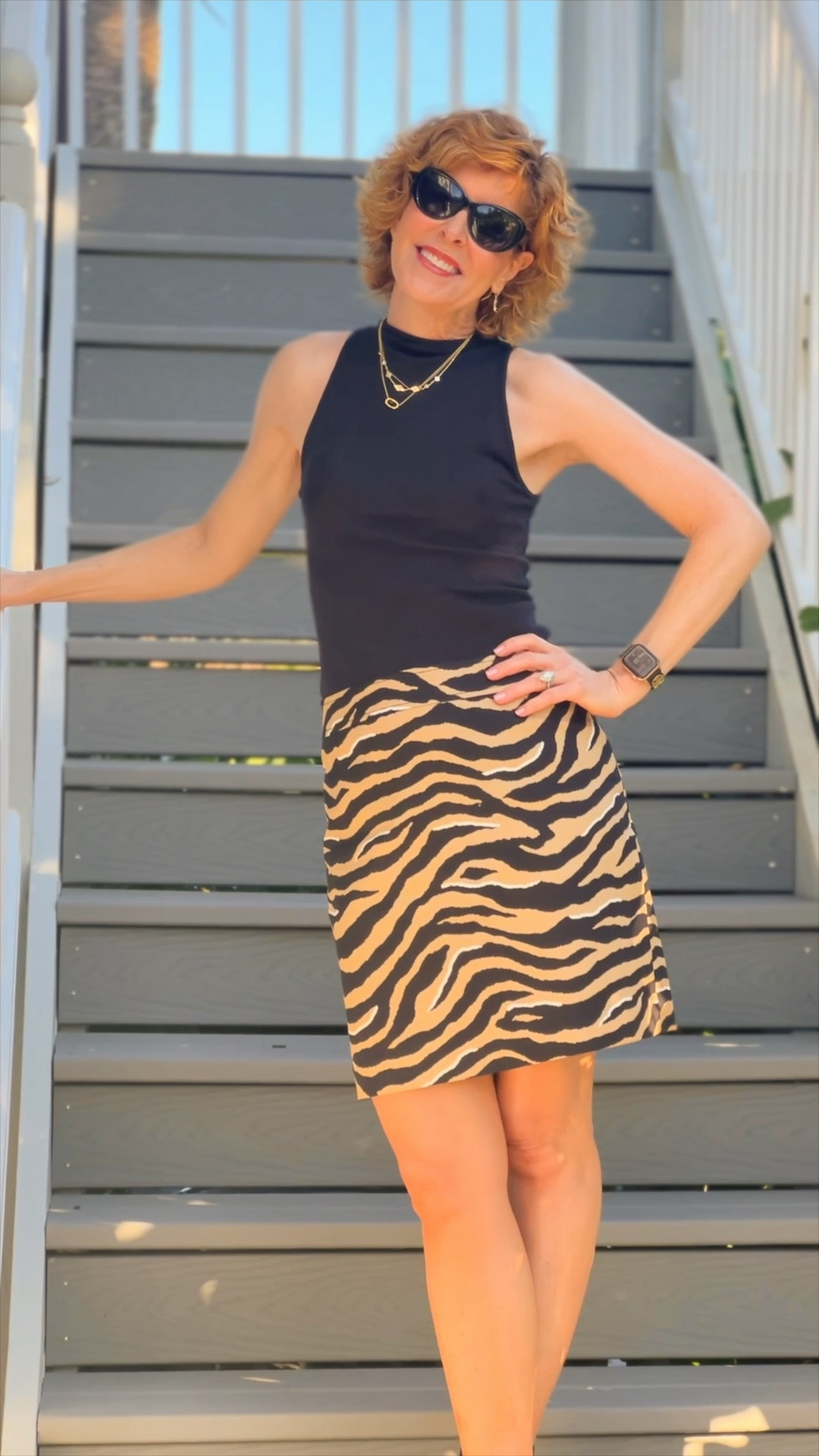 Fall Outfit, fall skirt, fall top, Animal print skirt, leopard print skirt, mock turtleneck, sleeveless turtleneck, black top, black mock turtleneck,
Black tank, black booties, black suede booties, black boots, gold
Necklaces, black earrings, black Apple Watch band

This classic mock turtleneck sleeveless tank is the ideal fall
layering piece. I love it paired with this twill animal print skirt that is 25% off right now. Add a moto black jacket if it’s cool outside and add black boots or booties..

#LTKsalealert #LTKshoecrush #LTKSeasonal