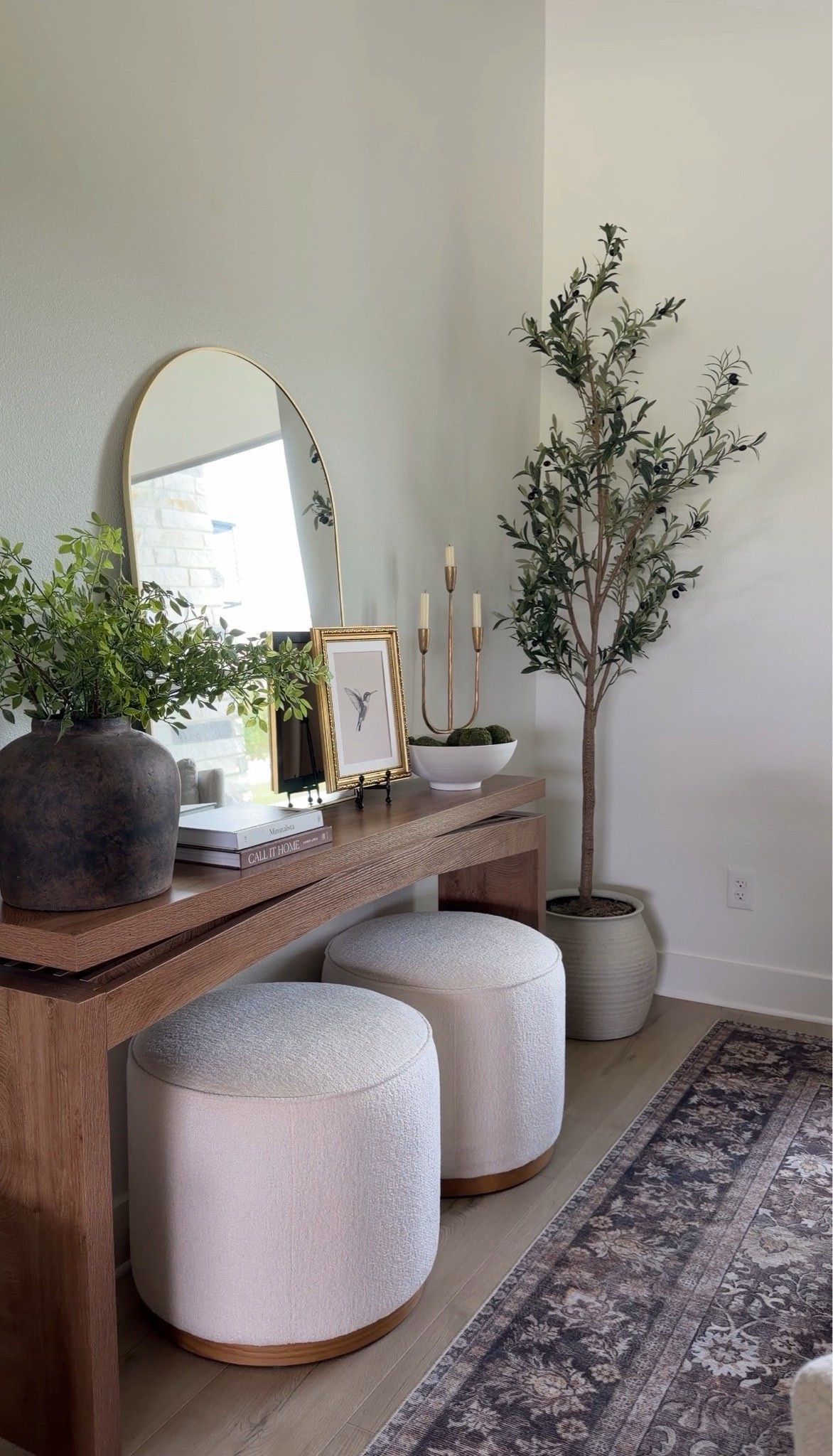 Designer-inspired entryway moment ✨

This beautiful console table is the perfect foundation for creating that elevated, collected look. Adding in a few styling must-haves like layered lighting, greenery, books, candles, and textured decor instantly makes the space feel warm, polished, and welcoming 🤍

Home decor, pottery barn inspired, home Inspo, console table, candelabra, greenery, stems, rustic vase, ottomans, olive tree, arch mirror

#LTKHome #LTKSaleAlert #LTKSeasonal