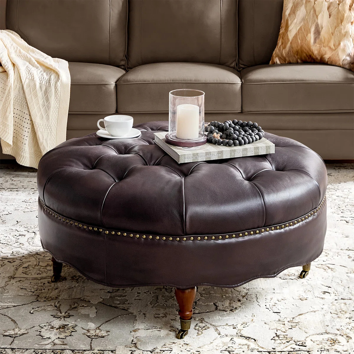 Gerardo 40"W Traditional Genuine Leather Ottoman with Tufted Top Nailhead Trim and Caster Wheels | Wayfair North America