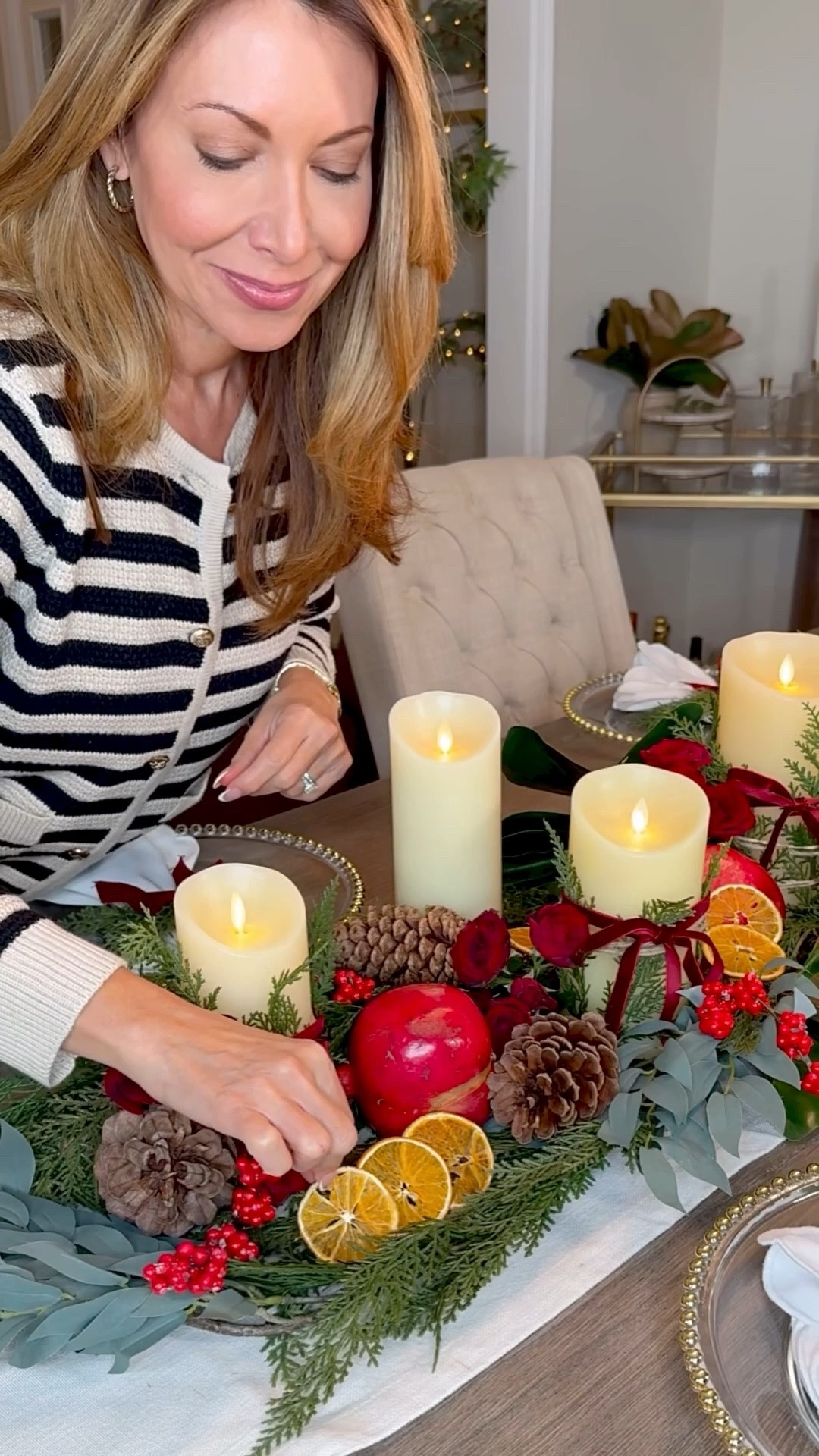Bringing a little holiday warmth to the table with candles, pine cones, and soft red accents. Details linked for anyone recreating 🤍