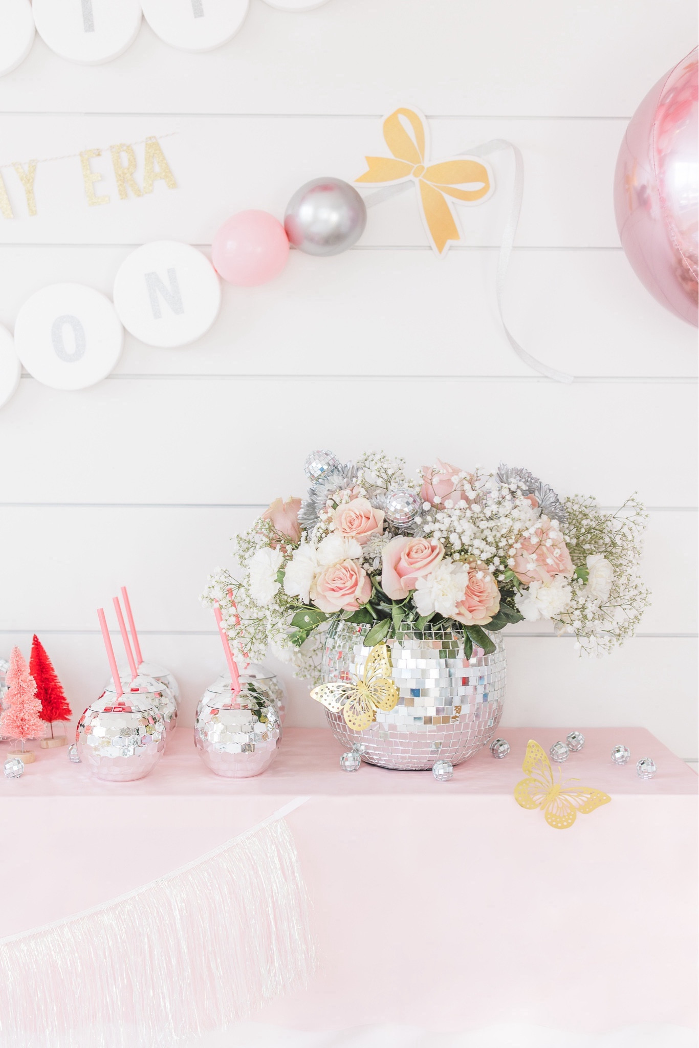 Taylor swift birthday party decor. I found these disco ball buckets/vases at TJ Maxx and filled them with flowers from the grocery store. I found some similar ones online for you. And to pull in some gold I added these gold butterflies that I applied using the glue dots it comes with. 

#LTKparties #LTKkids #LTKHoliday