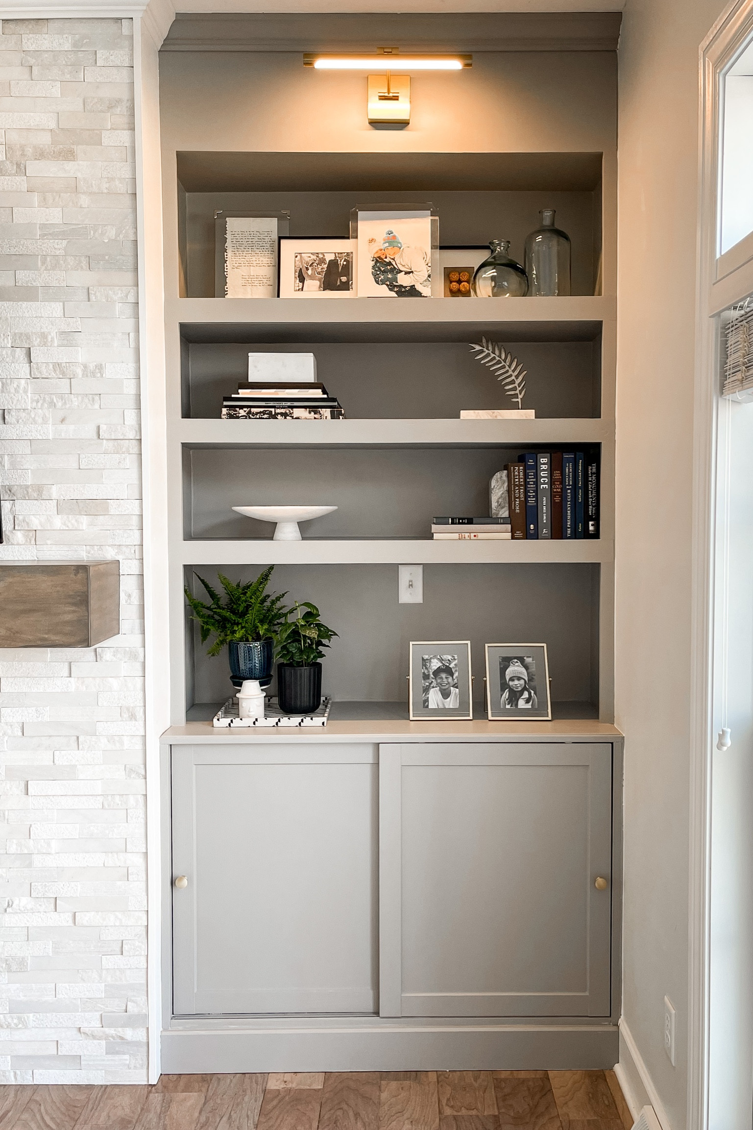 Living room - shelves and cabinets around fireplace 
Stacked marble fireplace, living room storage and display shelves, floating shelf mantle, open shelves decor, picture light 

#LTKstyletip #LTKFind #LTKhome