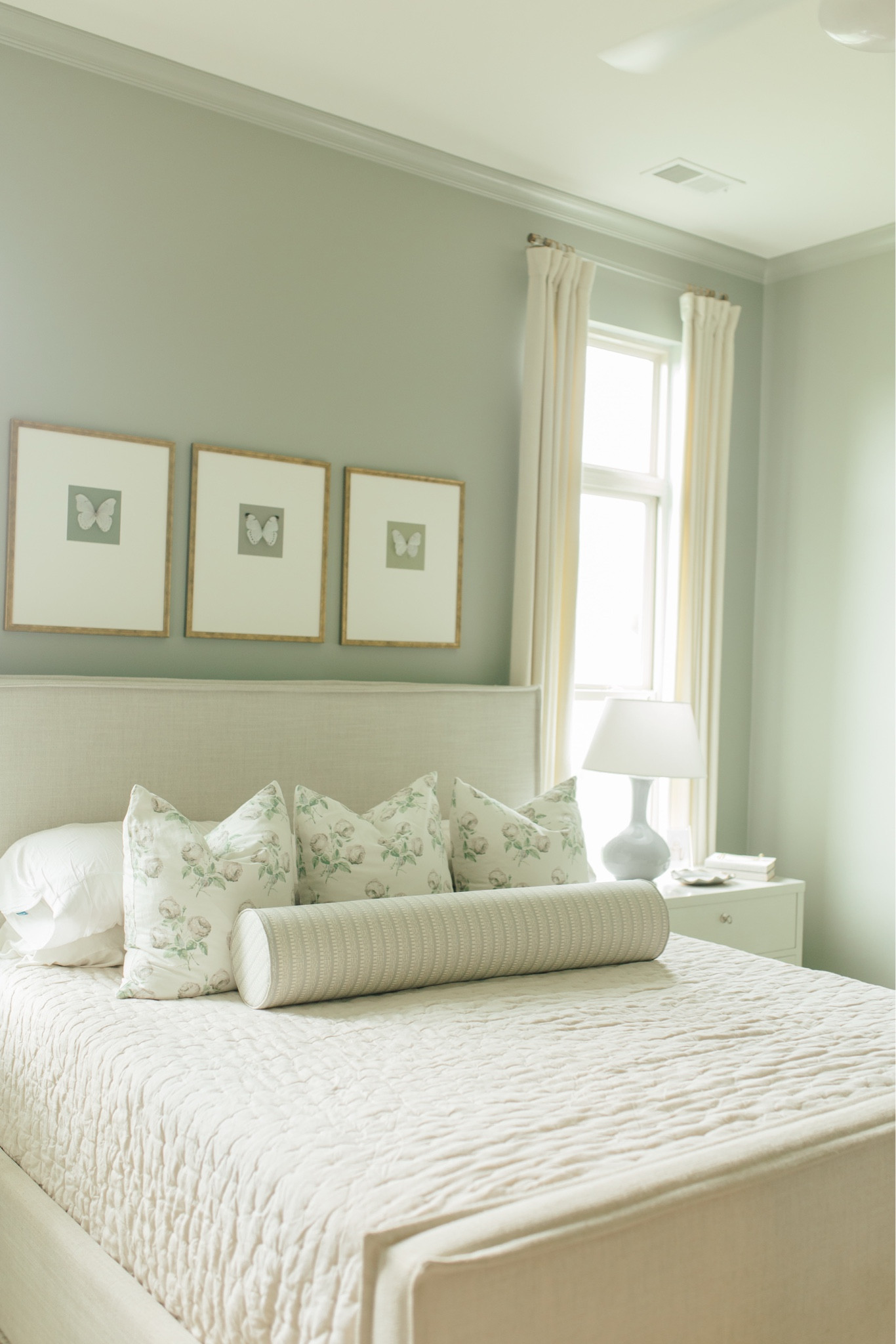 Southern garden inspired master bedroom decor. Neutral upholstered bed, bowood floral pillows, large round bolster, large French blue gourd lamps, butterfly art, and cozy bedding from Amazon 

Wall color: Blue Gray by Farrow & Ball

Lamp size: large French blue

#LTKStyleTip 

#LTKSaleAlert #LTKHome