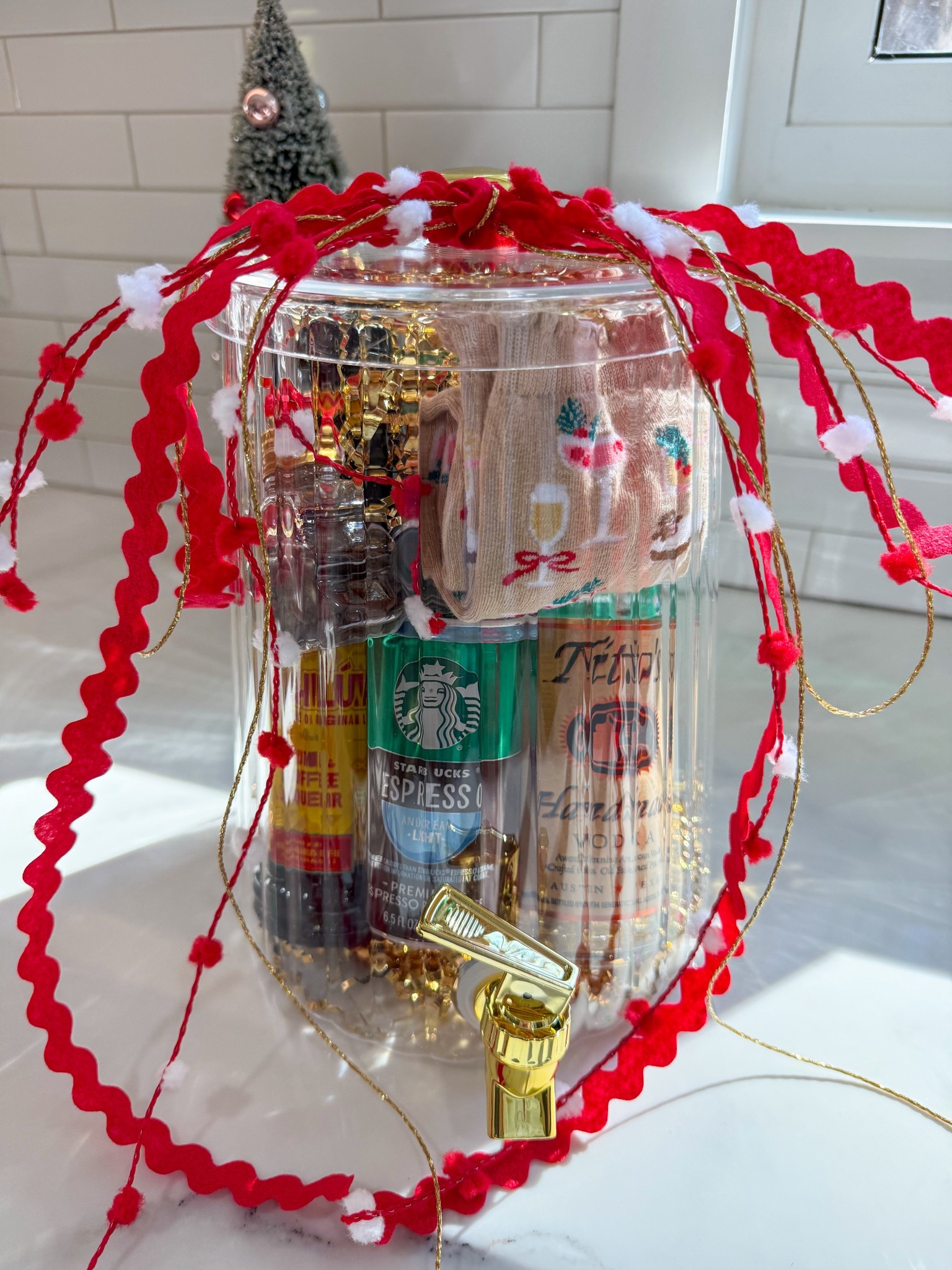 Batch Espresso Martini gift idea for the holidays! 

I filled this $10 drink dispenser with gold crinkle paper + added in 375 ml bottles of vodka and Kahlua. I then added in 4 small cans of the starbucks espresso coffees. What’s an espresso martini without a garnish?! So, I filled a plastic Christmas tree ornament with espresso beans to use as garnishes.

I also place some fun cocktail socks in as well because wearing festive socks around the holidays is my favorite! This gift would be great to give as a hostess gift or to your bestie this holiday season! 

#LTKParties #LTKGiftGuide #LTKHoliday