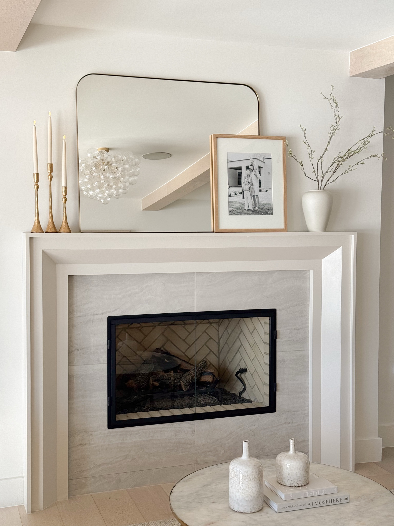 Elevate your mantel with simple yet elegant decor like gold candlesticks, a modern mirror, and natural accents. This layered look blends timeless charm and contemporary style for the perfect focal point in your living room.

#LTKStyleTip #LTKHome #LTKFindsUnder100
