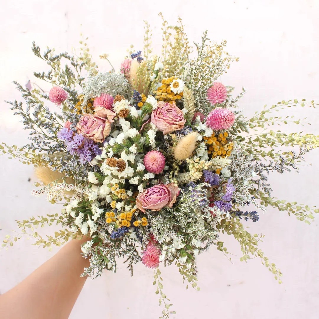 Soft, romantic, and effortlessly timeless—this Pink Dream & Purple Wildflowers Bouquet by Bridalwishdesign is a stunning choice for spring and summer celebrations. Designed with dried roses, blush globe amaranth, airy bunny tails, silver king herbs, delicate daisies, and natural grasses, it blends pink, purple, neutral greenery, and subtle orange tones for a beautifully balanced look. Each bouquet feels organic and one-of-a-kind, finished with your choice of twine, burlap lace, or ivory ribbon for that perfect wedding-day detail. A forever bouquet you’ll treasure long after “I do.” 💐✨ #LTKwedding #BridalBouquet #DriedFlowers #WildflowerWedding #BohoBride #SpringWedding #SummerWedding #WeddingInspo

#LTKHome #LTKSeasonal #LTKWedding