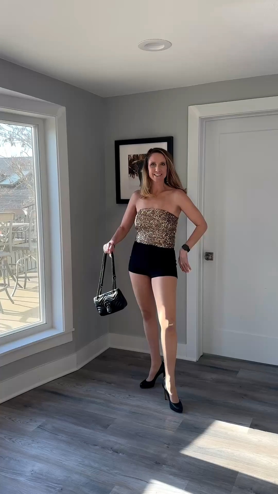 Trading the daytime neutrals for a little bit of gold sequin magic! ✨ There is nothing more unsettling for others than a woman who is comfortable in her own skin—and in these black micro-shorts and heels, I am definitely feeling that power. Ready to let the dance floor do the rest of the talking! Shop my full party look on my LTK! 🛍️ #NightOutStyle #SequinTop #GoldAndBlack #PartyOOTD

This high-glam ensemble strikes the perfect balance between sparkle and structure, making it an ideal choice for a night out or a festive event. By pairing a sequined gold tube top with high-waisted black micro-shorts, you’ve created a high-energy silhouette that emphasizes the waist and elongates the legs.
The Party-Ready Breakdown
• Metallic Shine: The gold sequin top catches the light from every angle, providing a luxurious, eye-catching texture that serves as the centerpiece of the look.
• Structured Minimalism: The sleek black shorts provide a grounded, matte counterpoint to the shimmer above, ensuring the outfit feels balanced rather than overwhelming.
• Classic Elevation: Finishing with black pointed-toe pumps adds a traditional touch of sophistication, creating a seamless line from the shorts down to the floor.
• The Final Touch: A small black shoulder bag keeps the accessories minimal, letting the sequins do most of the talking.

gold sequin tube top, black high waisted shorts, micro shorts, black pointed toe pumps, black leather shoulder bag, party outfit inspiration, metallic sequin top, night out fashion, evening glamour, LTKstyle


#LTKFestival #LTKActive #LTKOver40

#LTKSeasonal #LTKgrwm #LTKdayinmylife