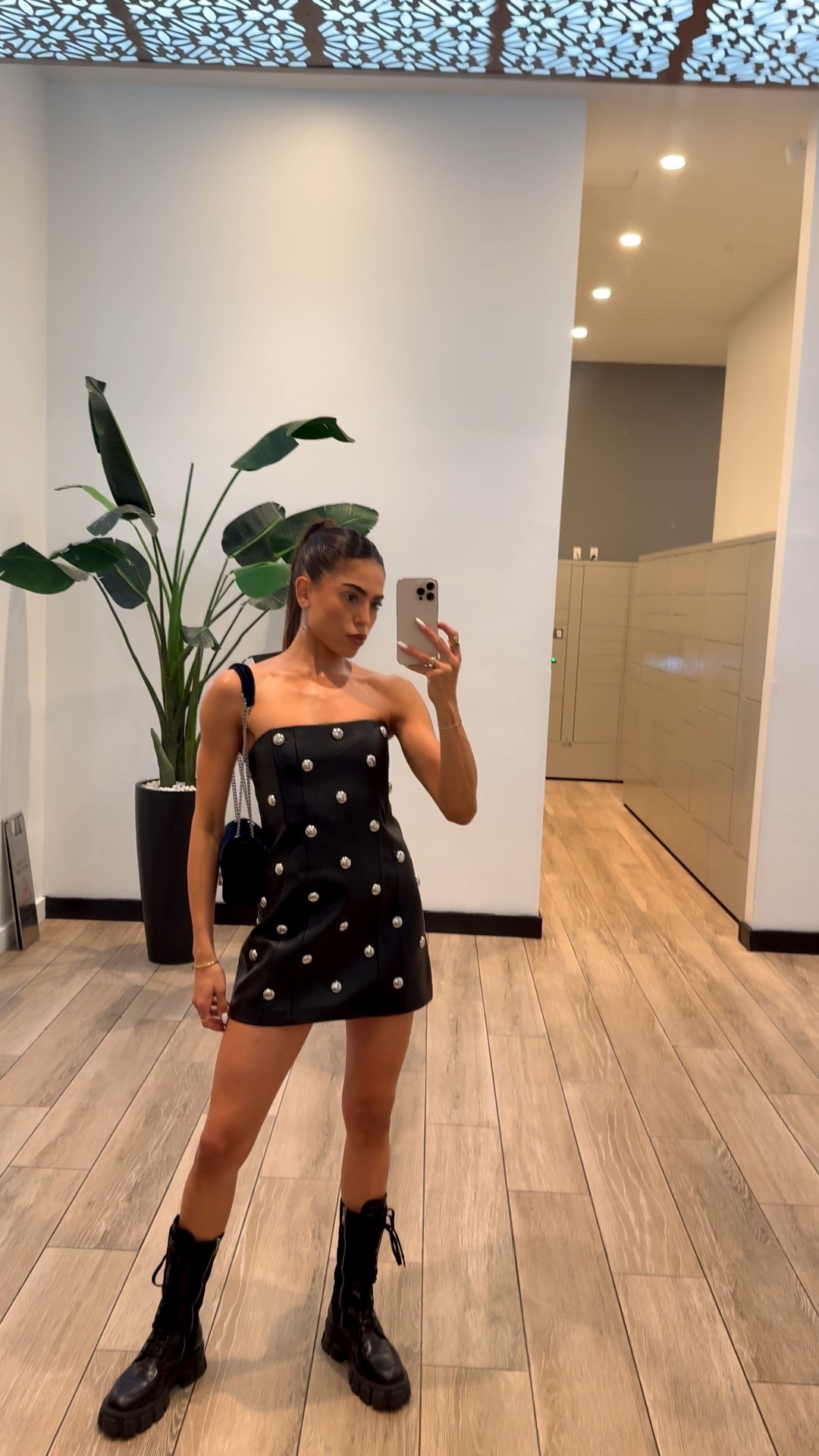 MANGO STUDDED FAUX-LEATHER DRESS 
Prada Boots 

#LTKBeauty #LTKgrwm #LTKGiftGuide