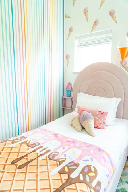 Our fun, vibrant, ice cream themed guest bedroom features a rainbow vertical stripes wallpaper, sundae sprinkles rectangular throw pillow and blanket, led night light lamp, elegant vibrant chandelier lighting fixture, pink floating square shelves, multicolor woven rug carpet, upholstered velvet bed with curved round headboard and light pink floral vintage retro rolling luggage suitcase 

- modern home decor, interior design, home ideas, best interior design, home accessories, furniture, house decor, fall decor, holiday decor, home accents, home styling, home design

#LTKhome #LTKkids #LTKfamily #LTKsalealert #LTKfindsunder50 #LTKfindsunder100 #LTKSeasonal