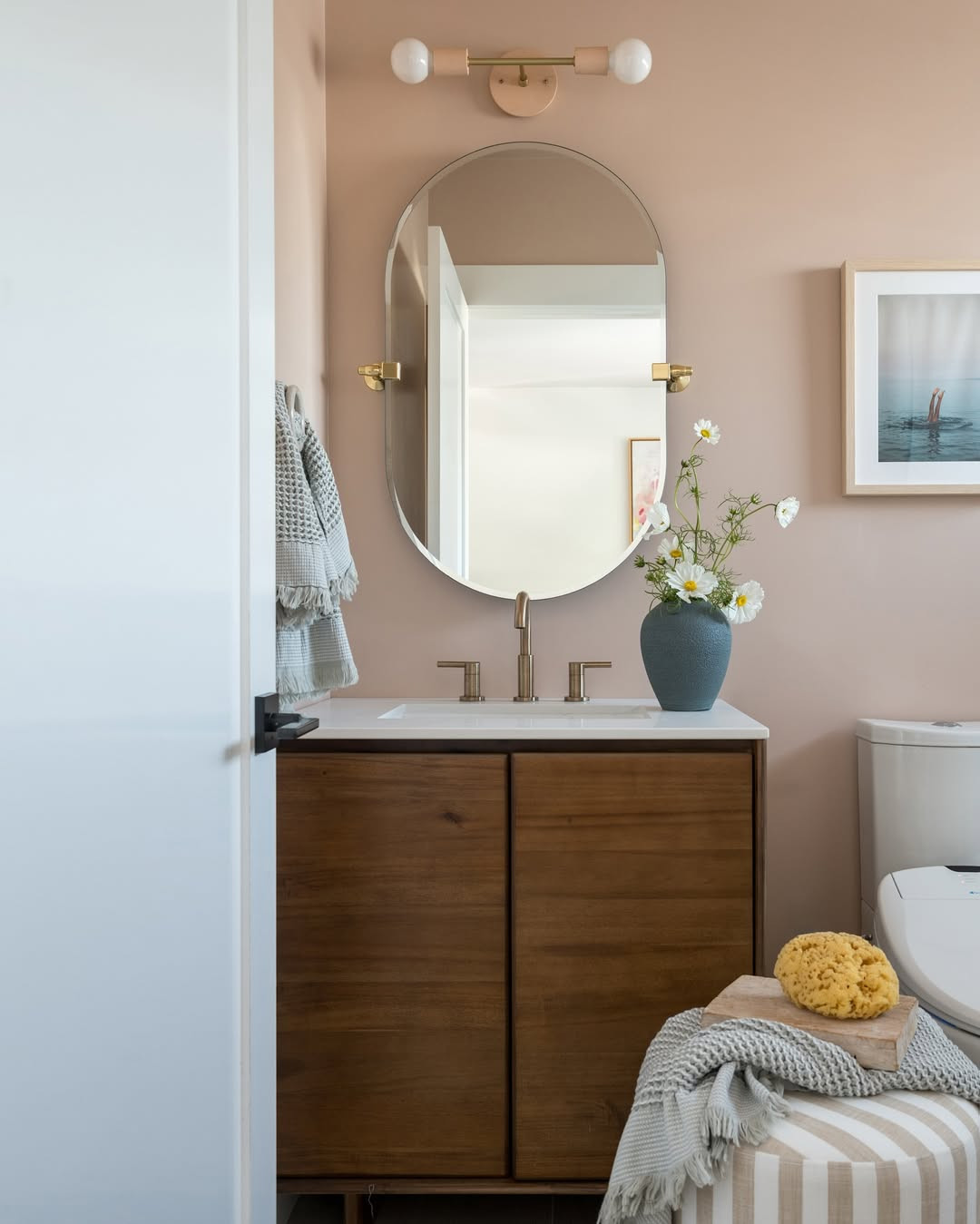 Every detail in this pink guest bathroom was chosen to feel playful yet elevated. Shop the exact vanity, faucet, mirror, hardware, and similar sconce, towels, art prints and more below. 

 #GuestBathroom #BathroomInspo #PinkBathroom #BathroomDecor #LTKHome