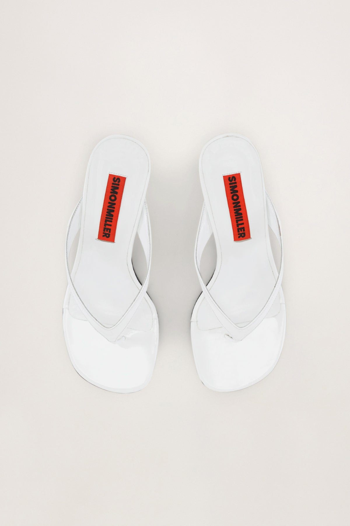 Beep
           Thong in White Patent | Simon Miller