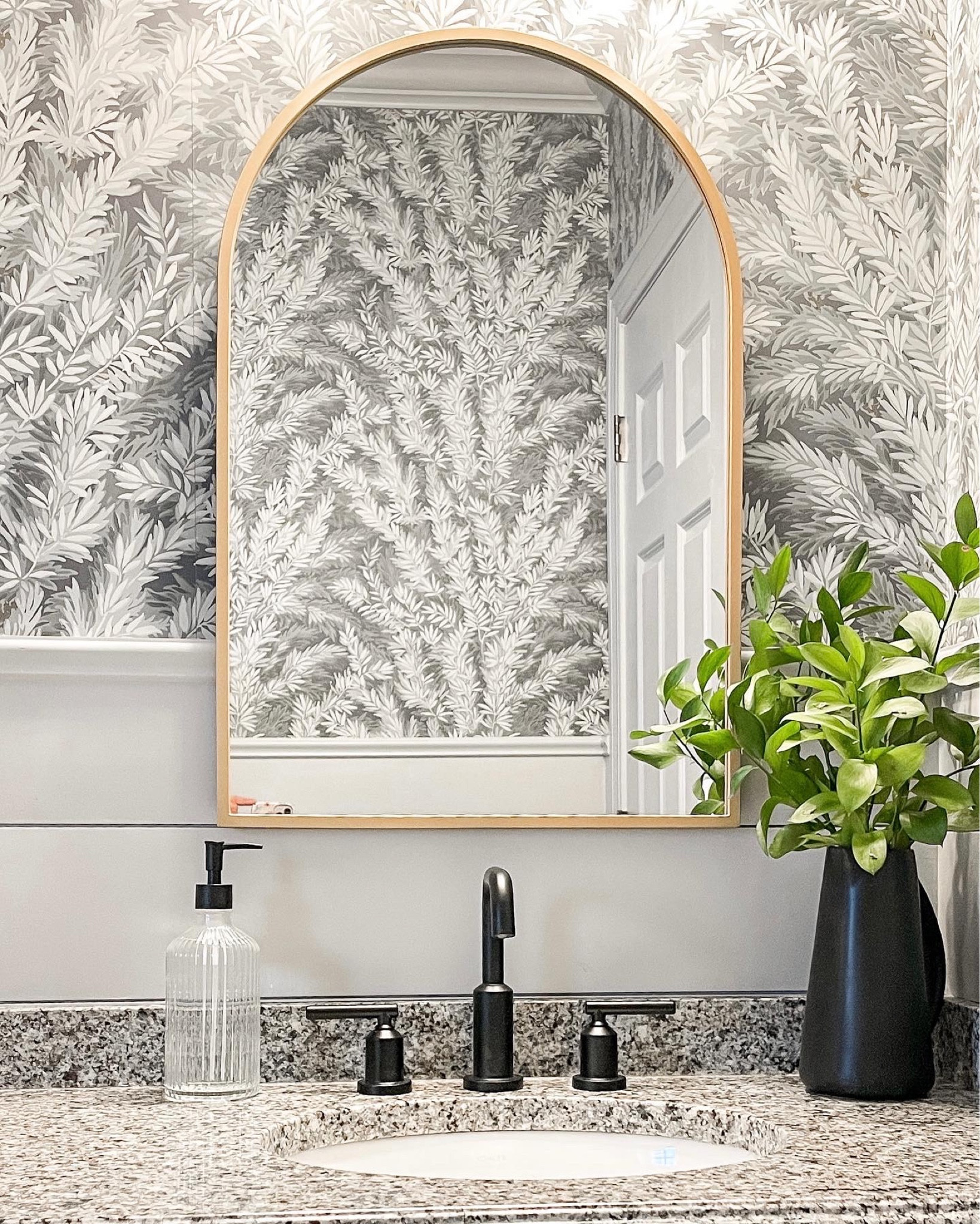 Powder room makeover, small bathroom decor | Wallpaper, arched bronze mirror, matte black faucet and accessories 

#LTKfamily #LTKstyletip #LTKhome