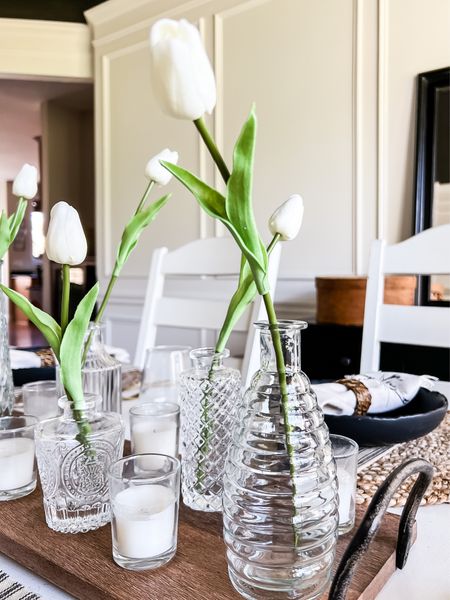 Style your spring table with these simple and affordable ideas! Clear glass bud vases filled with one faux tulip stem and small votive candles on a long wood tray. Neutral place settings for spring or Easter. #springtablescape #tablescapes #springdecoe

#LTKFind #LTKSeasonal #LTKhome