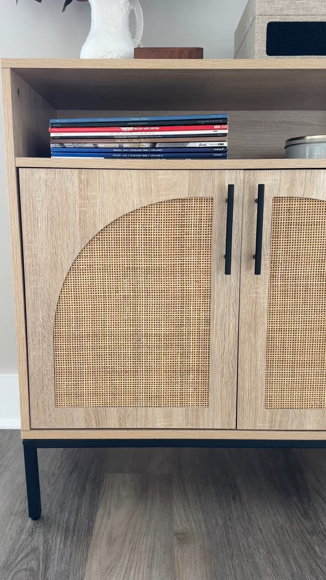 our rattan media cabinet is on sale for 57% off!! absolutely love this piece — i use it to store extra things we may need around the living area (candles, puzzles, etc) you could also purchase two and bump them up beside of each other to create a beautiful sideboard buffet situation in your dining area! mine is styled in our living area with our record player, records, seasonal florals, a candle, matches hidden in a cute spode canister, and some art above. | home decor, furniture, chic home, rattan furniture, light wood furniture, neutral home

#LTKStyleTip #LTKHome #LTKSeasonal