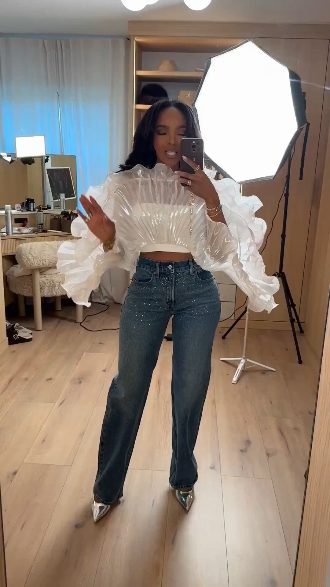 Hi Babes! 

This top is SUCH a statement piece 🤍 The dramatic ruffle sleeves mixed with denim gives that perfect balance of feminine and edgy while still looking high fashion. I love pairing standout tops like this with classic jeans because it lets the details really shine without making the outfit feel overdone.

This is definitely one of those outfits that makes people ask where your top is from. The sparkle denim and pointed metallic heels pulled everything together so perfectly for a glam dinner or fashion-forward event look.

Perfect for:
• Birthday dinners  
• Fashion events  
• Date nights  
• Girls night out  
• Holiday dinners  
• Elevated denim looks  

Everything is linked below ✨

xx Kira | IG: KirasFashionFinds

34D - 27 - 40 • Size Small or 4