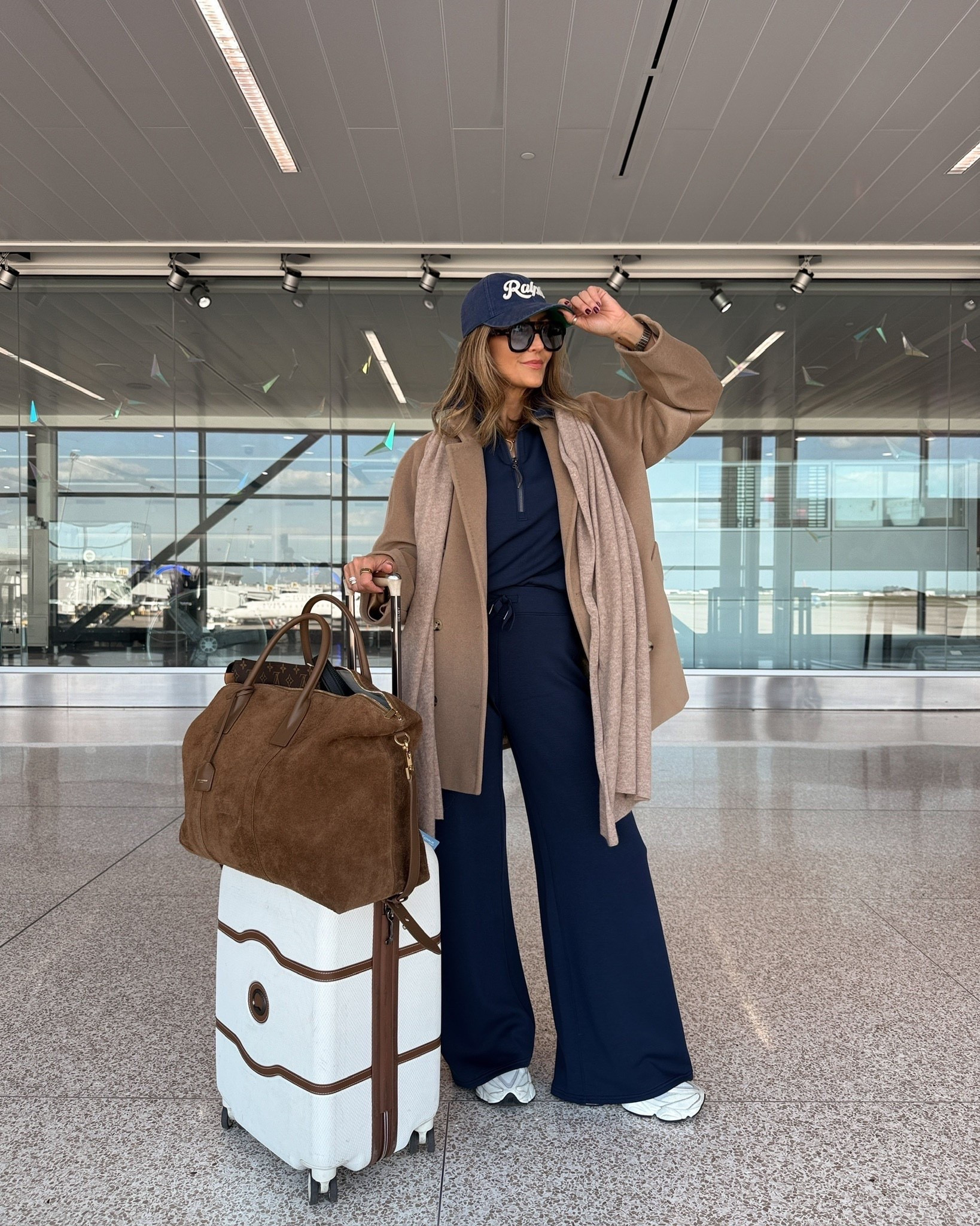 The perfect airport outfit with this Spanx set in navy, keeping the travel look sporty and chic. 20% off my set with code LTK20

#LTKTravel #LTKOver40 #LTKSeasonal