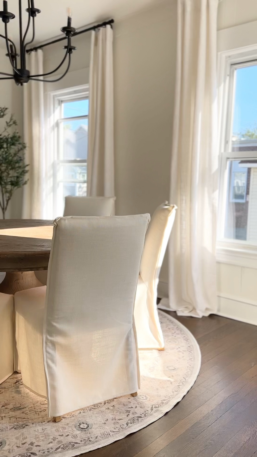 not sure what part pulls this room together more..the Amazon curtains, the ruggable rug, the crate and barrel dining chairs, or the faux olive tree… 😍