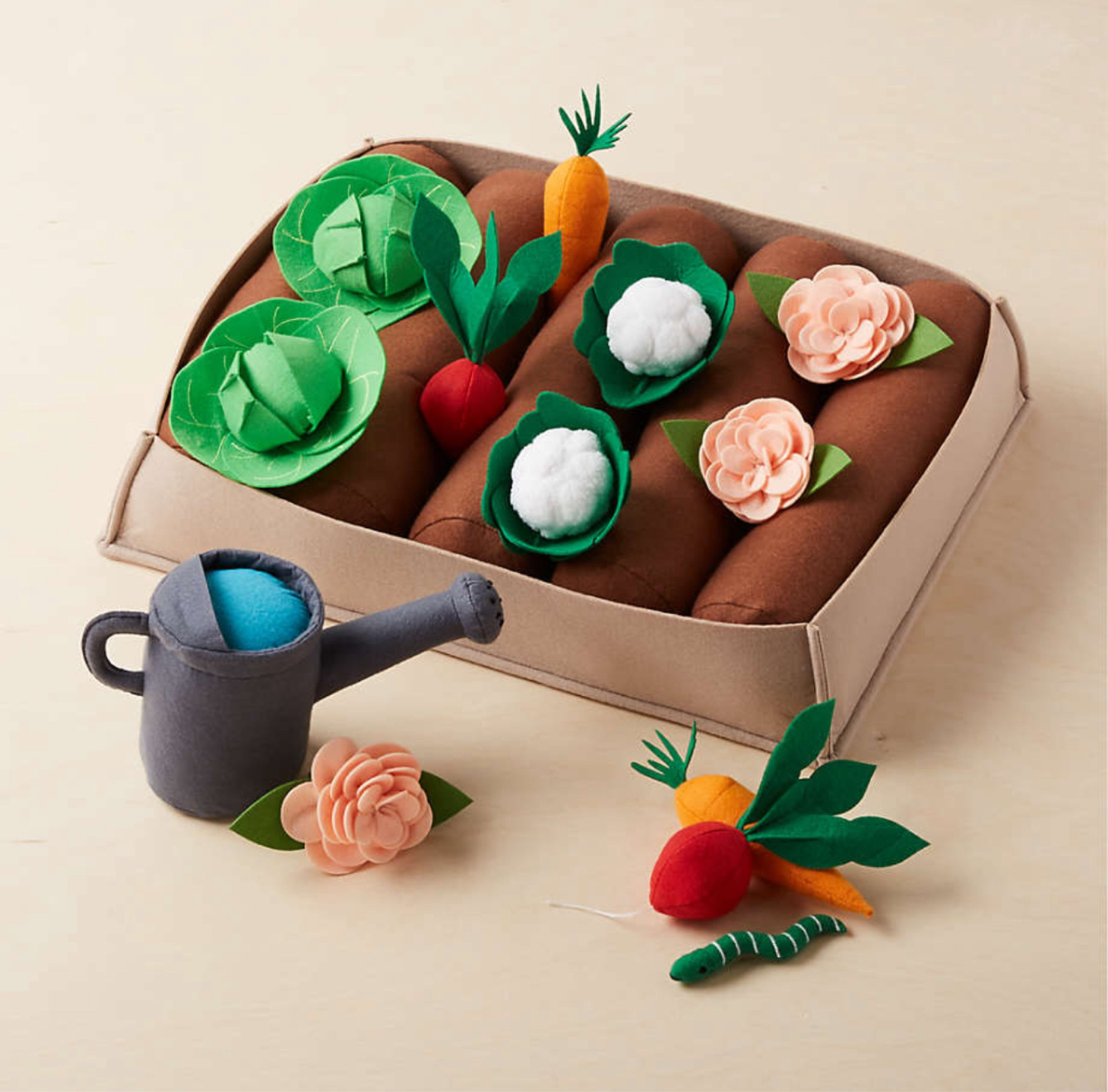 With our felt garden set around, imagination will always be in full bloom. A smart choice for growing gardeners, this 19-piece lineup includes toy flowers, carrots, lettuce, cauliflower, radishes, a watering can and an adorable worm. Pretend to plant it all in the tray, and use the brown bolsters that look like soil. It makes a fine addition to our Greenhouse Playhouse, and will keep your little sprout make-believing through the seasons.
What's more: this immersive kids' toy makes for a wonderful gift.
•19-piece imaginary play gardening set
• Includes felt tray with 5 bolsters to plant your garden, watering can, worm, 3 flowers, 2 carrots, 2 heads of lettuce, 2 heads of cauliflower, 2 radishes

#LTKBaby #LTKKids #LTKFamily