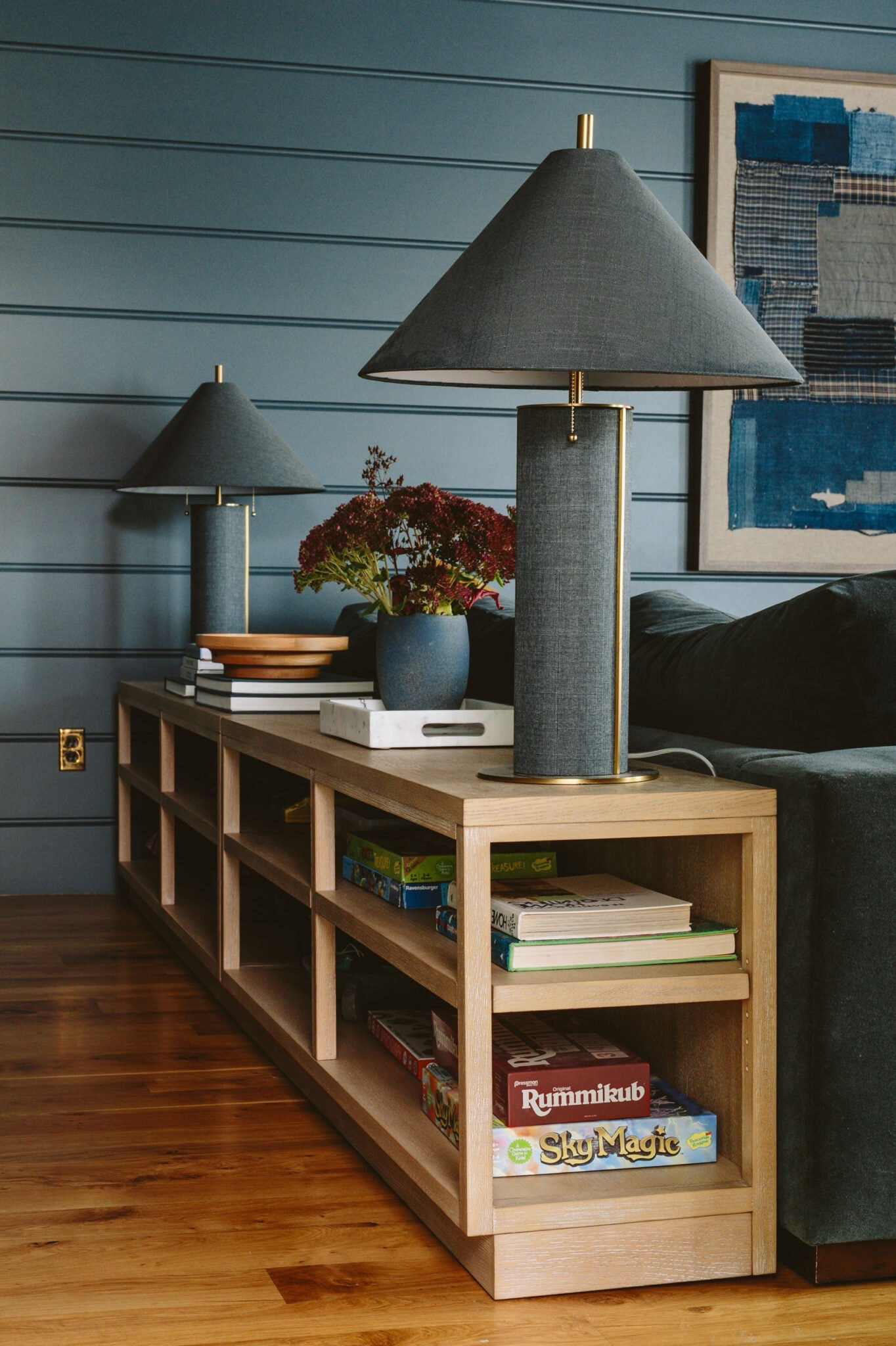 We didn’t need a ton of storage in here, just enough for games and puzzles really. But the real problem that we had was not having a surface for lamps or drinks. Since the sofa is slammed up against the far wall and there was hardly any room for a side table on this side of it, we needed a sofa table. Enter this bookcase from Pottery Barn that fits PERFECTLY along the back of the sofa and is where my wine or tea sits when I’m watching TV (as well as those gorgeous lamps). It looks fully integrated and almost like it was professionally designed!

#LTKCyberWeek #LTKhome #LTKfamily