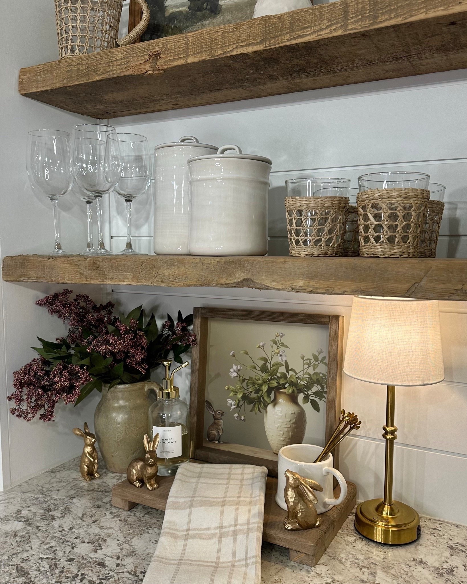 Spring Coffee Bar. Follow @farmtotablecreations on Instagram for more cozy home styling and seasonal finds.

This coffee bar is giving the prettiest early spring refresh 🤍 I styled the open wood shelves with simple glassware, neutral canisters, and woven textures to keep the space warm and inviting. The brass bunnies add a subtle seasonal touch, and the framed artwork brings everything together beautifully. Finished with a small lamp and folded linen towel for a collected, lived-in feel.

For reference:
• Artwork size 12x12 in Briarsmoke stain
• Code FARMTOTABLE for 15% off
• Wood riser size 16” x 9.25”
• One berry stem used

#coffeebar #kitchenstyling #openshelves #springdecor #neutralhome #brassaccents #countertopdecor #kitchendecor #shelves 

#LTKHome #LTKSeasonal #LTKSaleAlert