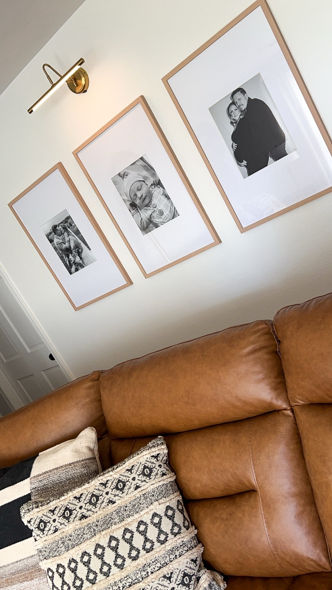 Cozy corner vibes 🤎 Neutral leather, textured pillows, and our most treasured moments in warm wood frames — simple touches that make a house feel like home.

#LTKHome #LTKFamily