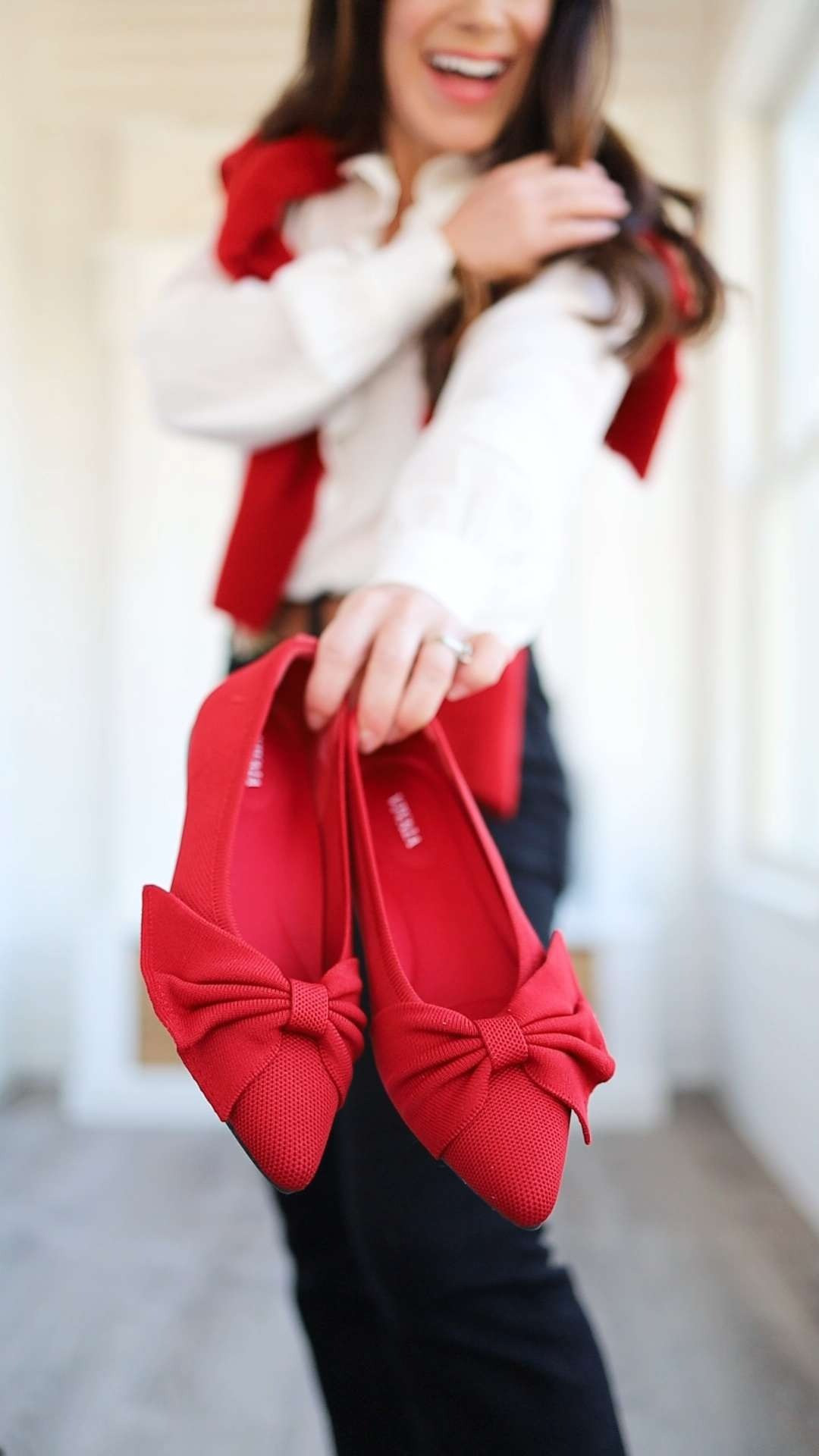 Valentine's Day romance that doesn't feel too "on the nose" - Embracing the upcoming holiday with a casual denim look, centered on Sezane's Chlo blouse and the most adorable red bow flats. This VIVAIA shoe is a winner. Connect it all together by tossing a cashmere sweater over your shoulder. 

Valentine's day outfit | feminine blouse | red flats | pointed to flats | Valentine's Day look #LTKValentine 

 #LTKValentine #LTKSeasonal #LTKPetite