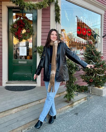 Holiday winter outfit with black leather jacket, light wash denim jeans, oversized plaid scarf, and black leather boots. 

#LTKHoliday #LTKSeasonal