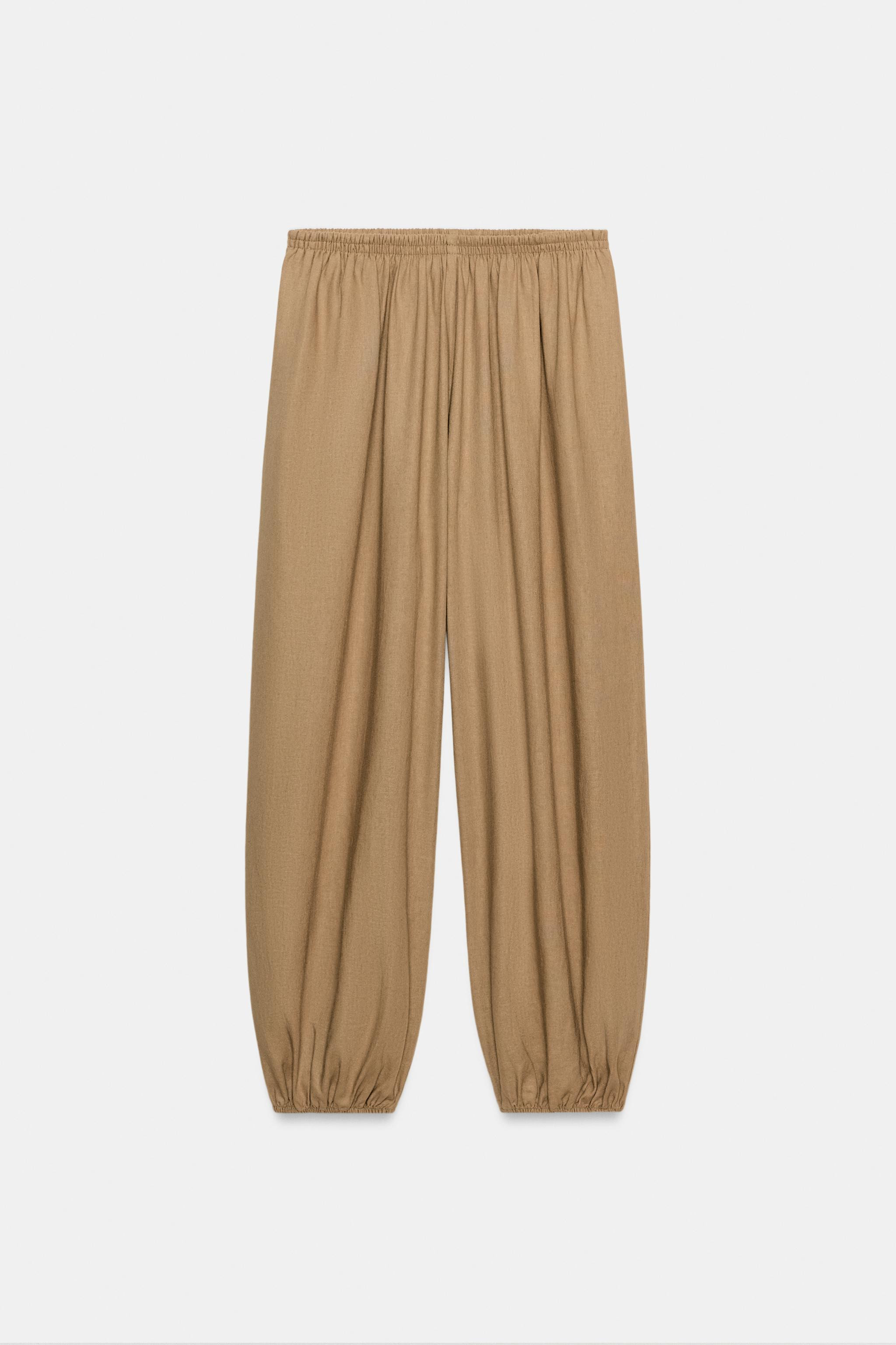 Trousers made from a linen blend. Featuring a mid-waist with an elastic waistband and front pocke... | Zara UK