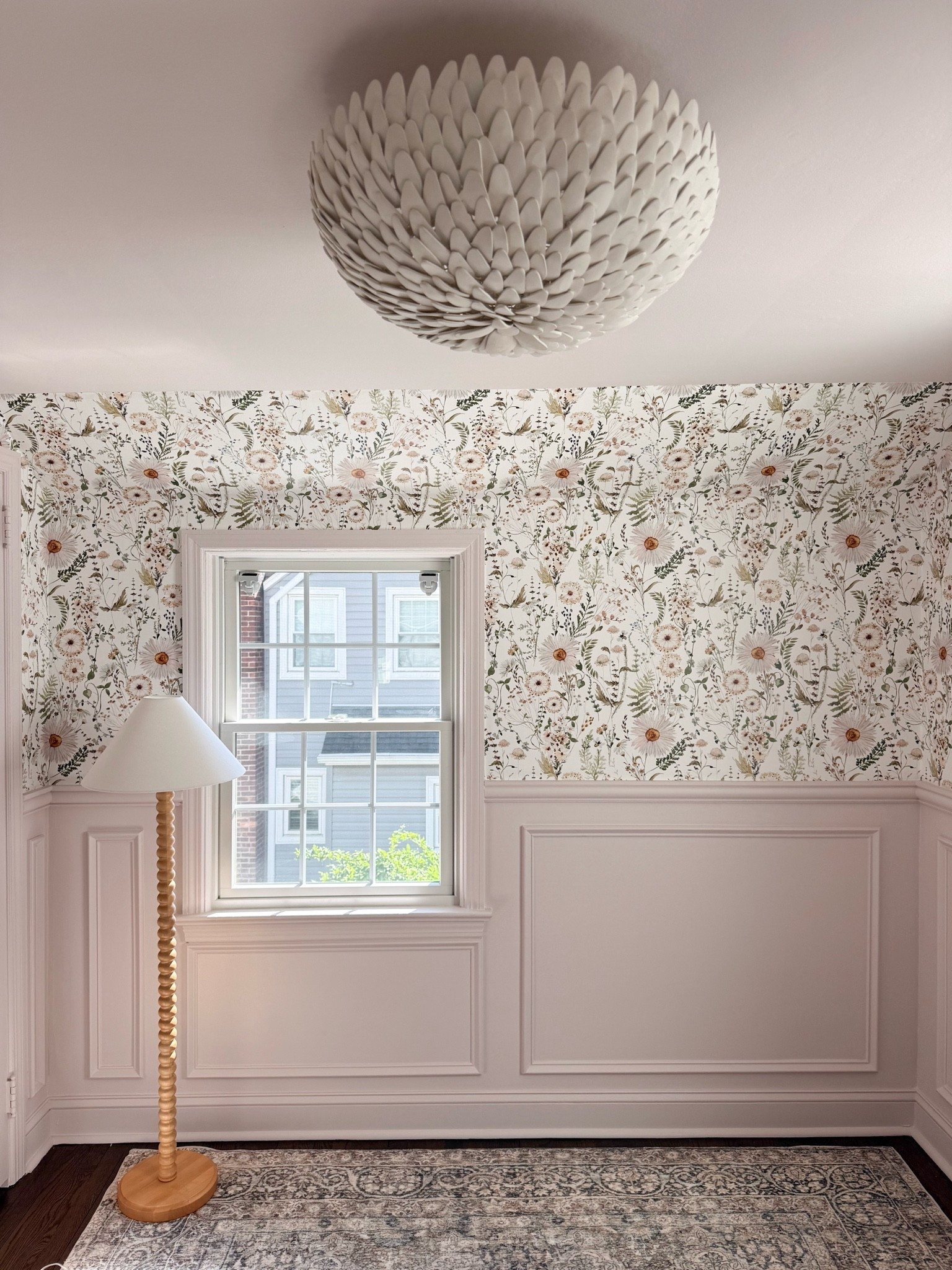 This wallpaper is such a beautiful statement in this space. I love how the delicate floral pattern works with the classic wall molding, warm wood tones, and layered lighting to create a room that feels feminine, timeless, and collected.

floral wallpaper, floral room decor, wallpaper inspiration, classic home decor, wall molding ideas, traditional interiors, feminine home decor, statement wallpaper, timeless interior design, neutral home decor, layered lighting, girlonthehudson