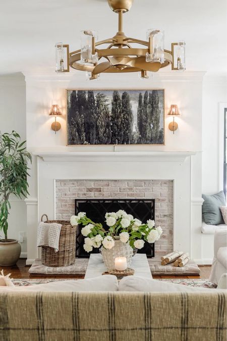 Living room  updates — We spray-painted the chandelier to get this bronze gold color! 

Frame TV, fireplace decor, mantle decor, floral stems, summer decor

#LTKhome