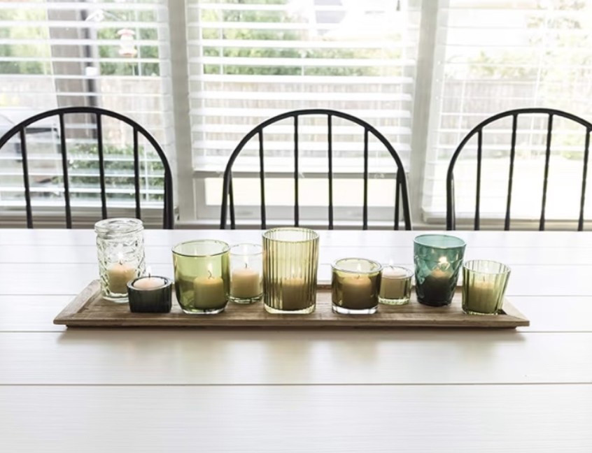 Wood tray with green glass votive holders that brings that warm gathered-around-the-table glow to a space. ✨ Perfect for dining tables, patio dinners, coffee tables, kitchen islands, entryways, holiday hosting, or cozy evening styling when you want soft candlelight and a more collected farmhouse look. The natural wood tray and green glass holders give it that rustic old-world feel while still working beautifully in modern homes. 

Add this piece if your home needs a cozy centerpiece for slow evenings and warm ambient lighting. 🌿

#LTKHome #LTKOver40 #LTKSeasonal