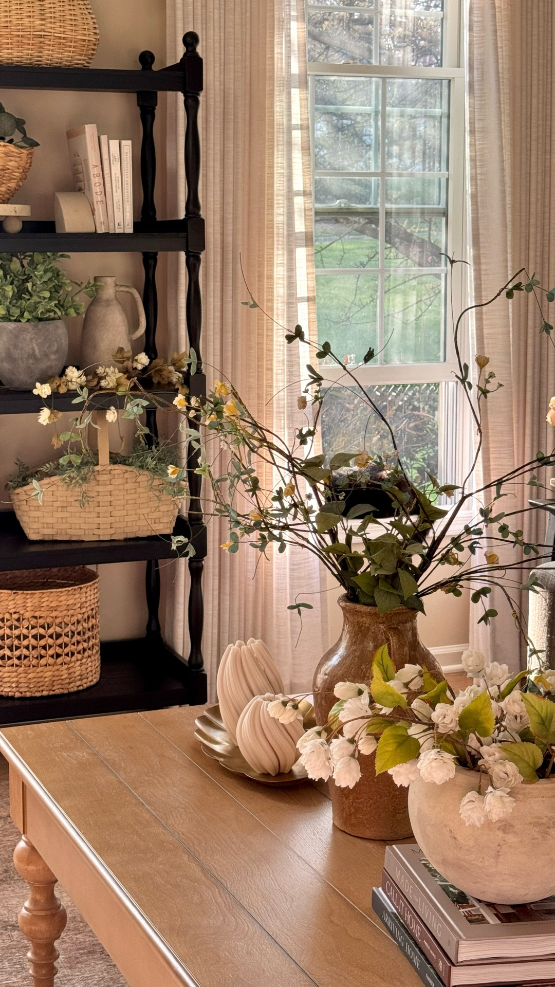 Living room styling:

Gorgeous custom linen curtains currently on sale! I have the Liz Linen in Beige White, Pinch pleat, Memory shape  

Coffee table -currently 65% off! 
Neutral area rug
Electric wall sconces
Neutral wooden wall art
Coffee table books
Hops stems
White planter
Black tall book shelf
Similar green lamps
Solid wood end table 
Pillow cushions

Sofa is from Best Home Furnishings - unable to link   

#LTKHome #LTKSaleAlert