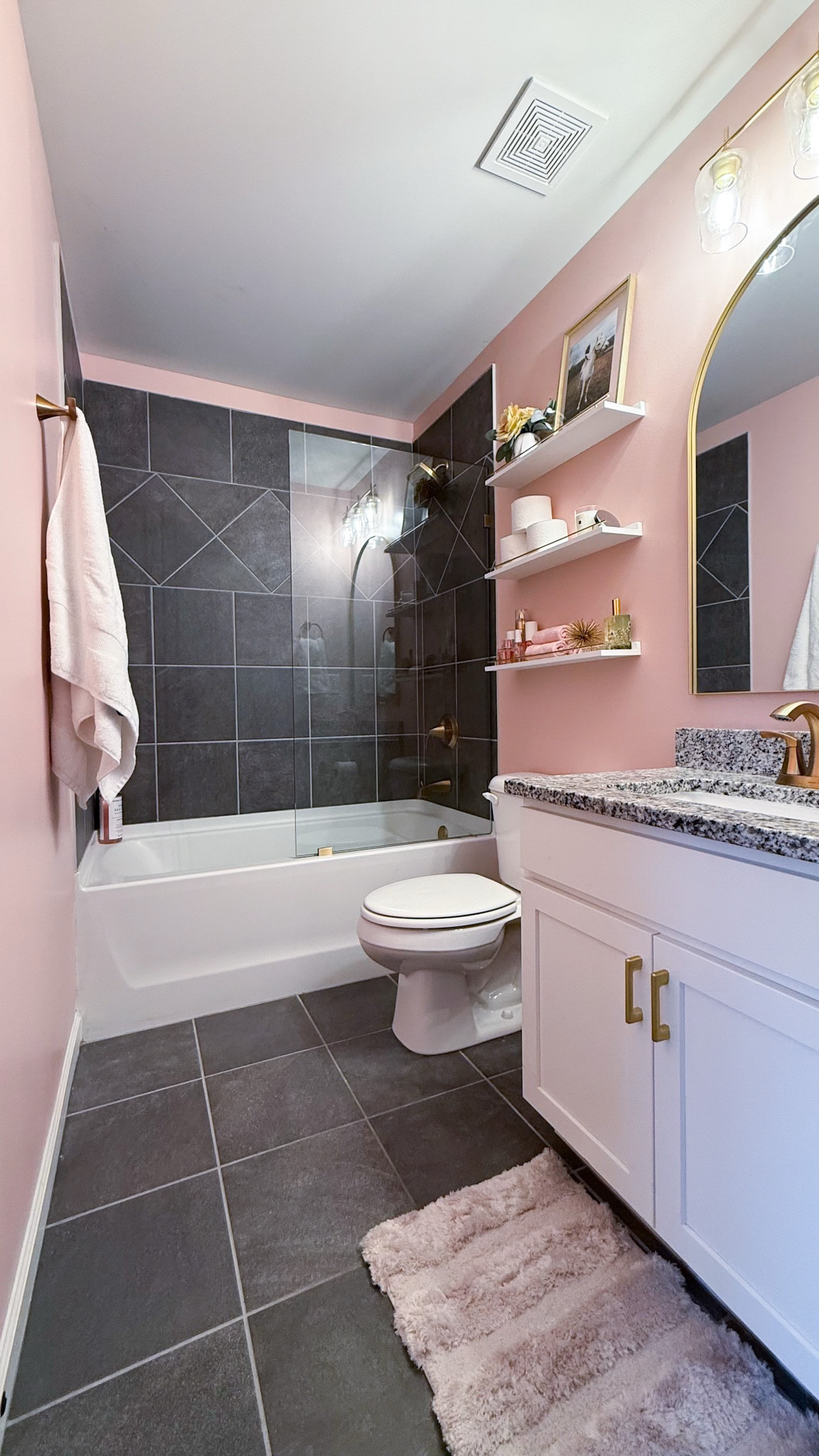 We couldn’t change the tile, but we could change the vibe. This bathroom felt dark and heavy—gray on gray with no personality. A blush paint refresh, new gold hardware, and a sleek shower door made it feel so much brighter #BathroomRefresh #DIYMakeover
#weekendproject #diywithme

#LTKFamily #LTKHome #LTKKids