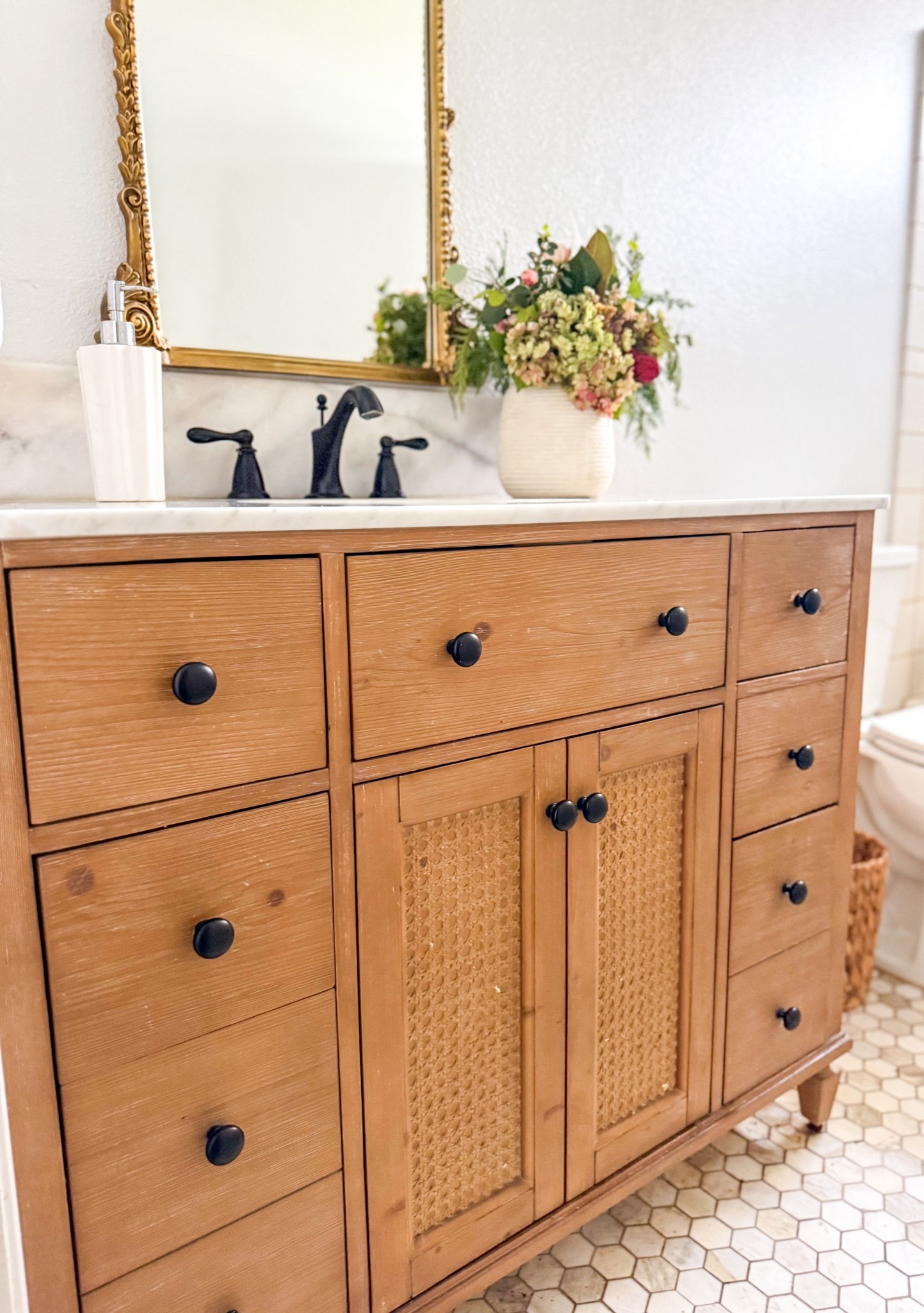 My love is strong for this gorgeous bathroom vanity from @wayfair! It has six soft closed drawers and one cabinet. It’s spacious enough for drawer organizers and cabinet organizers too! I love everything about it, especially the caned detailing on the cabinet doors and the modern black hardware! It looks amazing with my ornate gold mirror! #ad #wayfair #wayfairpartner #newyearnewyou 

#LTKmorningroutine #LTKSaleAlert #LTKHome