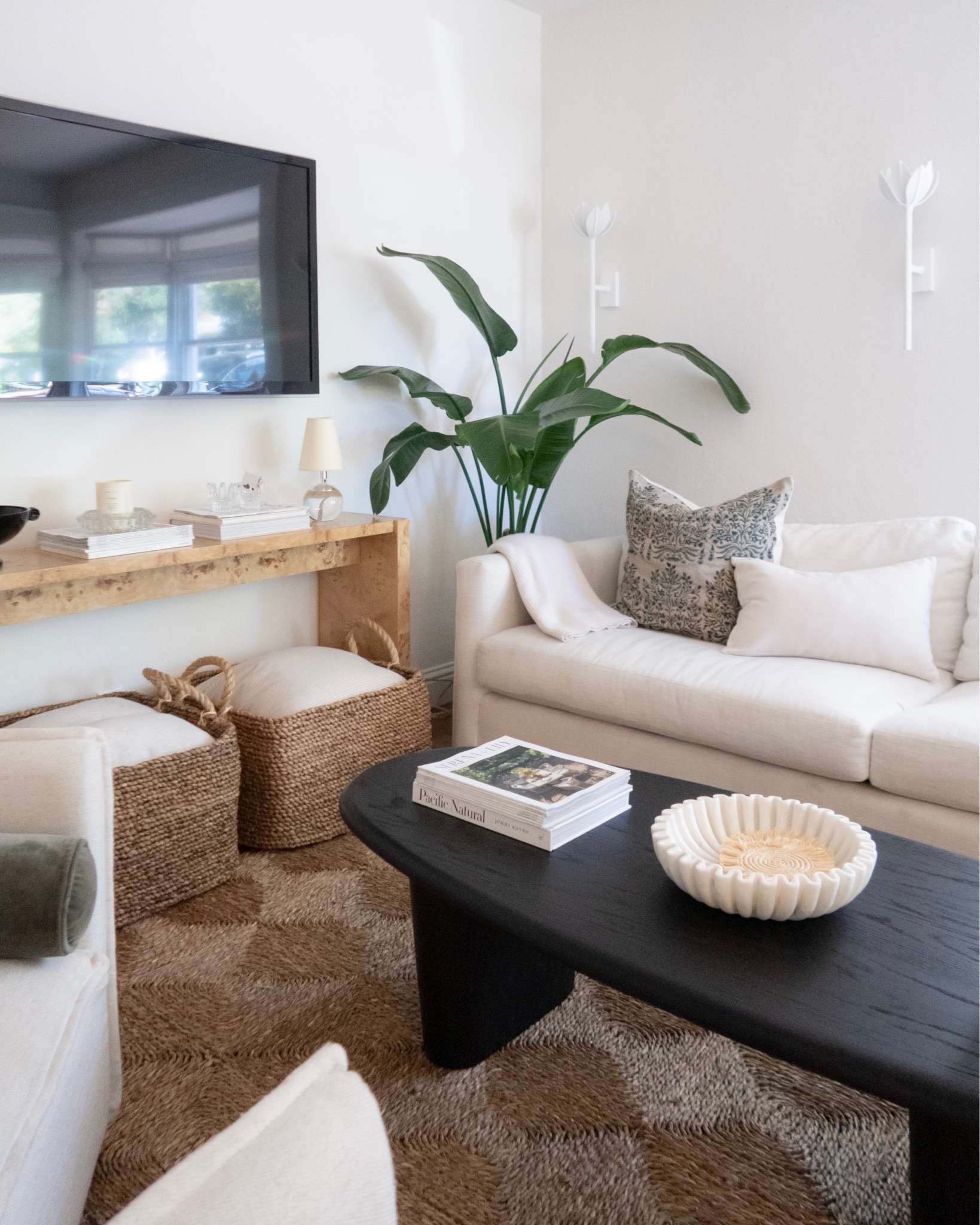 Thrilled to have finished up our living room with the help of @thehavenly! When we moved into our Napa home (a significant downsize), I knew it wouldn’t be without obstacles, specifically when it came to layout and design in the living room thanks to a window seat, funky front door swing interference and just a general small footprint. @thehavenly and our designer @dianawhiteinteriors helped our cozy dreams come true mixing some of the pieces we already had and love within a layout that maximizes space and function, while creating a room we can layer throughout the years—truly just what I wanted. Sharing more from the design process on my site + @havenly has graciously offered 25% off all interior  design packages (Mini, Full and In-Home) with code GIRLMEETSGOLD25. 🤍 #HavenlyPartner #Havenly 

Maiden Home Warren Sofa
CB2 Burl Wood Console Table
Lulu and Georgia Coffee Table
Rush House Seagrass Rug
Blinds.com Roman Shades Helena Birch
Visual Comfort Sconces

#LTKstyletip #LTKSeasonal #LTKhome