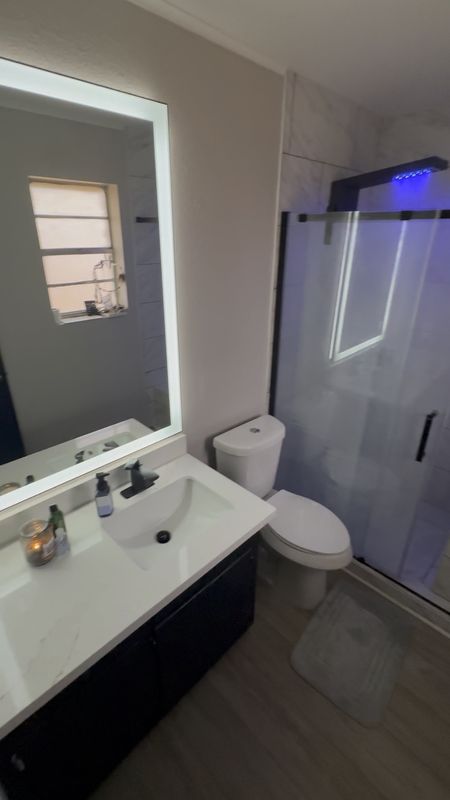 The Master En Suite Glow Up of 2024. 
Home Renovation flipping never looked so modern & fresh. 🫶🏻 Black Matte Fixtures in the bathroom, accent the modern Euro shower tower and quartzite countertops. Obsessed with this Gigantic LED framed backlit mirror,  to maximize lighting and open up the space! 

#ledmirror #homerenovatione #fliphome #bathroom #showertower #homereno #

#LTKhome #LTKVideo #LTKstyletip
