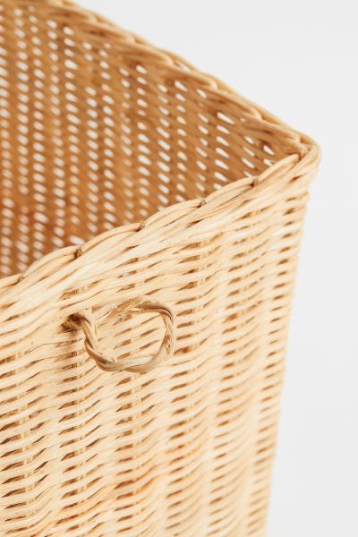 Tall storage basket in braided rattan with a small handle at one short side. Height 10 1/2 in. Wi... | H&M (US + CA)