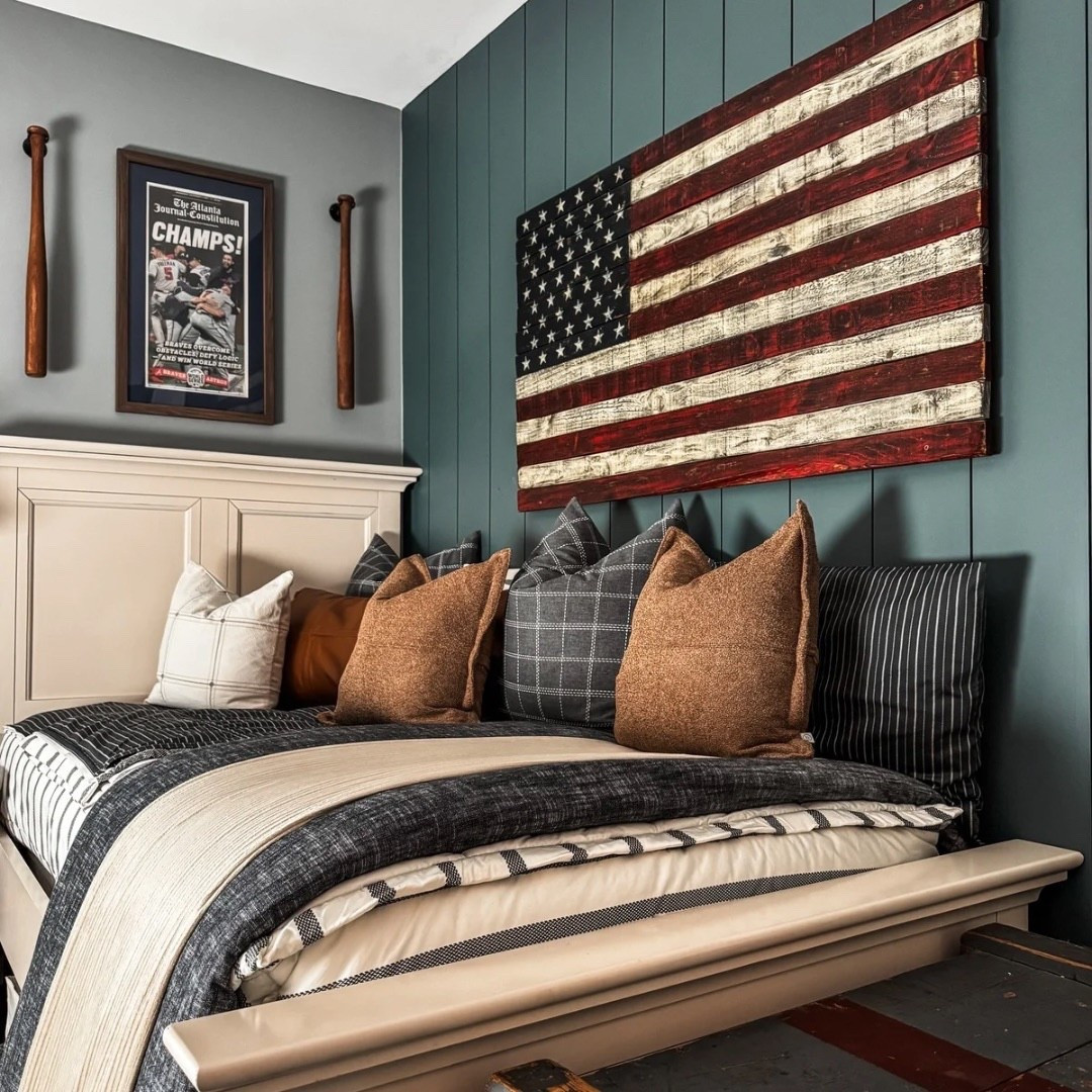Cozy + collected 🤍 A crisp white bed frame anchors the room, styled with striped bedding, layered blankets, and stacked accent pillows for comfort. The wood nightstand and brass wall sconce bring warmth, while sporty touches—like the framed championship poster, baseball bats, and American flag wall art—add character. Under-bed storage baskets and a patterned rug complete this stylish, practical bedroom. 🌟

Bedding by Beddy’s
Code EANES = 20% off 

Bedding Details: 
Chandler Beddy’s (Twin, Cotton, ZipBase)
Taylor Luxe Blanket 
On-the-go blanket tan grid 
Owen Luxe Leather XL Lumbar Pillow Cover
Lincoln Medium Pillow Cover
Monroe Medium Pillow Cover 
Lucas Euro Pillow Cover


#BedroomInspo #LayeredBedding #AccentPillowStyle #WoodFurniture #BrassLighting #SportsInspiredDecor #BaseballRoom #AmericanFlagDecor #UnderBedStorage #RugGoals #eanesinteriors


#LTKHome #LTKStyleTip #LTKOver40