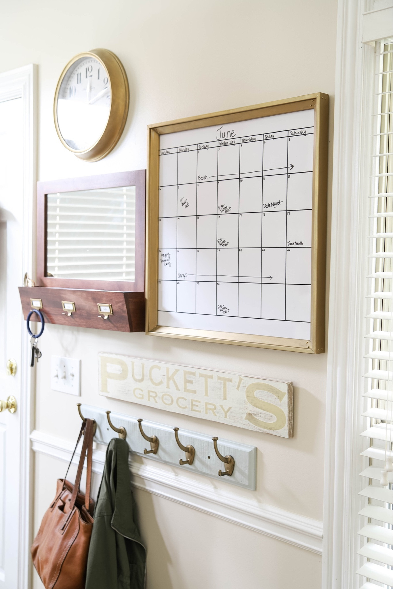A calendar, clock, mirror, key hooks and coat hooks are an essential part of my back door/kitchen organization area.

#LTKhome