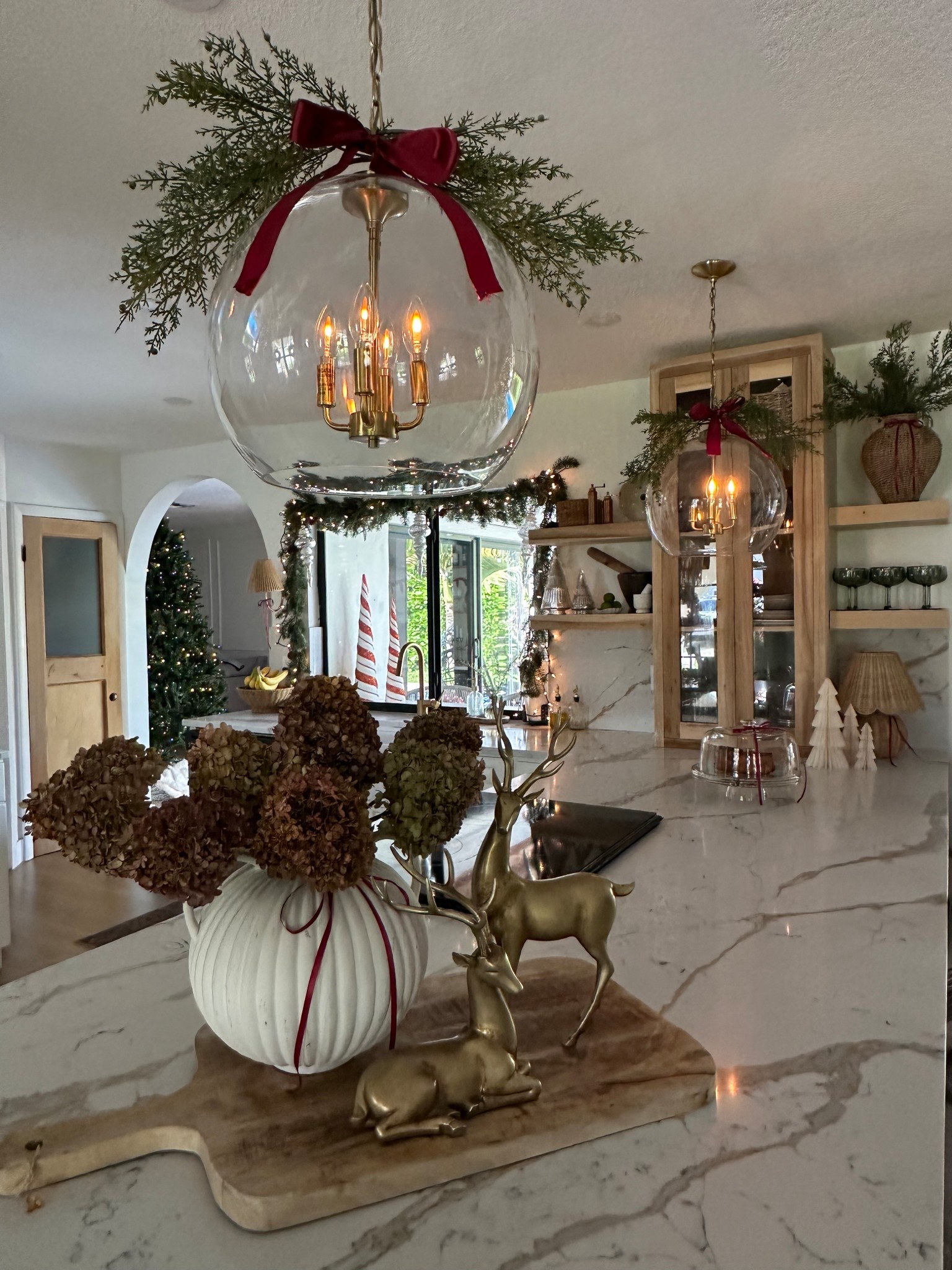 Vintage inspired Christmas Kitchen chandelier decor. 

Christmas kitchen island and chandelier! Love adding this festive touch to our island and pendant lights. The red bows bring everything together. Winter Stems are from Hobby Lobby. 

Garland 
Winter stems 
Now
Red now 
Vintage Christmas 
Kitchen Christmas 
Pottery barn 
Walmart 
Target
McGee and co 
Magnolia 
My Texas house 
Reindeer 
Holiday 
Kitchen 

#LTKHome #LTKFindsUnder50 #LTKSaleAlert