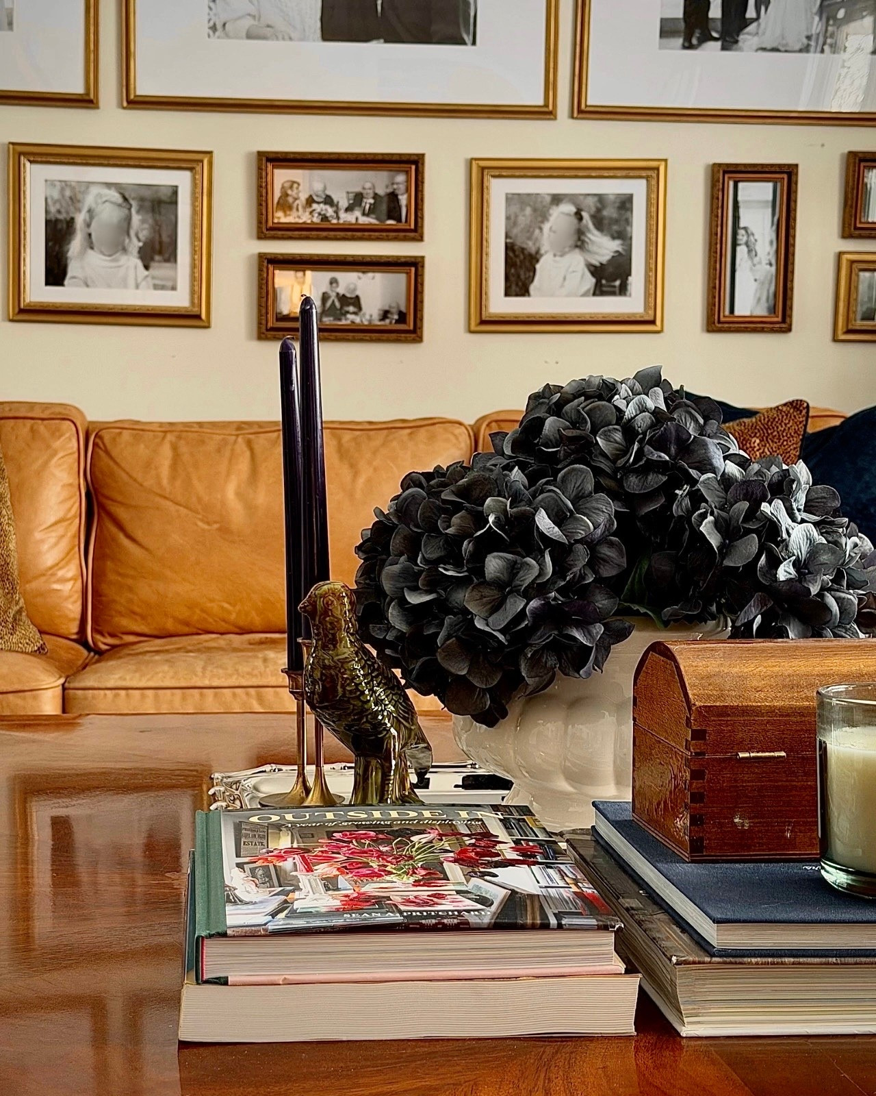 A warm, traditional living room layered with camel leather, a curated black-and-white gallery wall, and moody hydrangeas for contrast. Styled coffee table details — stacked design books, brass candlesticks, a vintage bird figurine, and a classic wooden box — create that Ralph Lauren–inspired aesthetic that feels timeless, personal, and beautifully collected. Perfect inspiration for traditional home decor lovers who appreciate depth, texture, and heritage style.

Save for classic home decor and elevated living inspiration.

#liketkit 
#ClassicHomeDecor #TimelessInteriors 
#TraditionalHome #MaeveAndJames

Follow my LTK @Maeve&James on the @shop.LTK app to view this post and shop this look!

#LTKHome