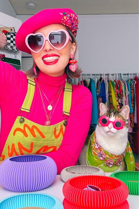 get ready with me and Pony ✨💖 

Champagne wears a hot pink turtleneck, long sleeve shirt and a green and orange overalls. With pink heart lips earrings, pink heart, sunglasses and beret. Pony wears a green and orange scarf with gold and pink jeweled necklace and flower sunglasses. 

Dopamine dressing, Maximalism, maximalist, vibrant, colorful, cat pet, cute animal holiday .

#LTKSeasonal #LTKHoliday