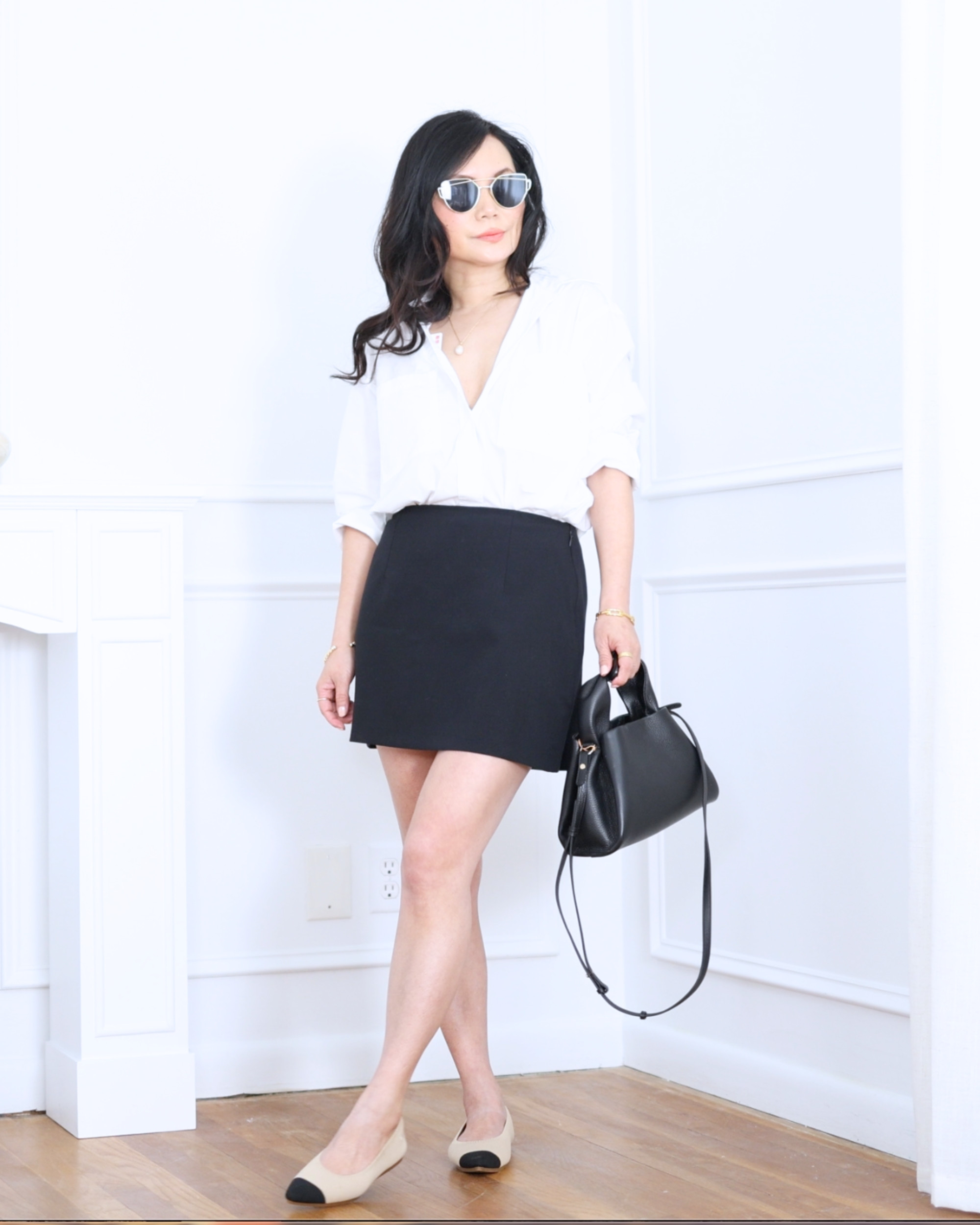 White boxy shirt from Uniqlo paired with a black mini skort from Abercrombie and pointed-toe ballet flats from Vivaia — clean, playful, and effortlessly polished for everyday wear. I'm 5'2, wearing size S. 

 #LTKootd #LTKOver40 #LTKPetite